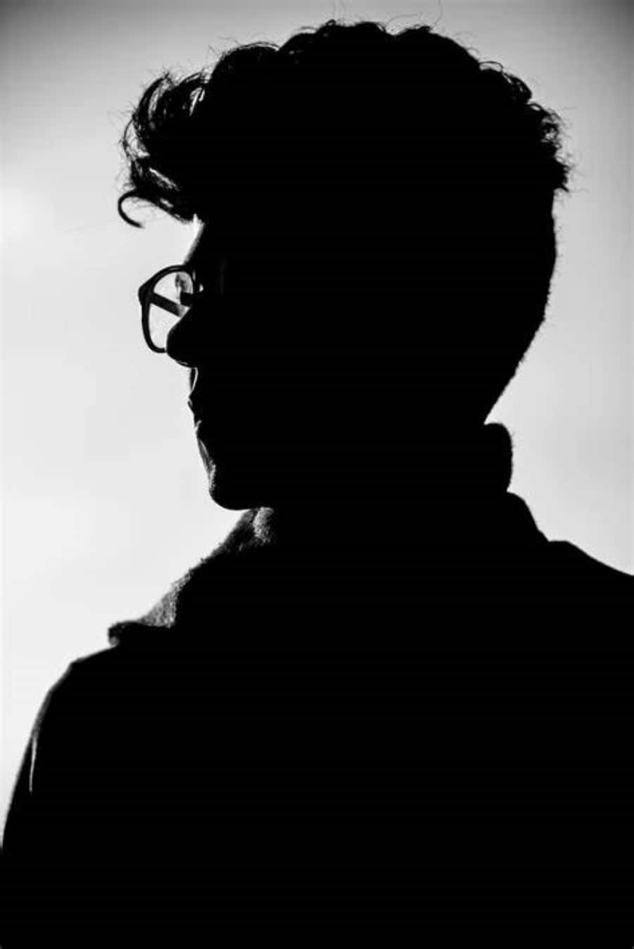 a silhouette of a man with glasses