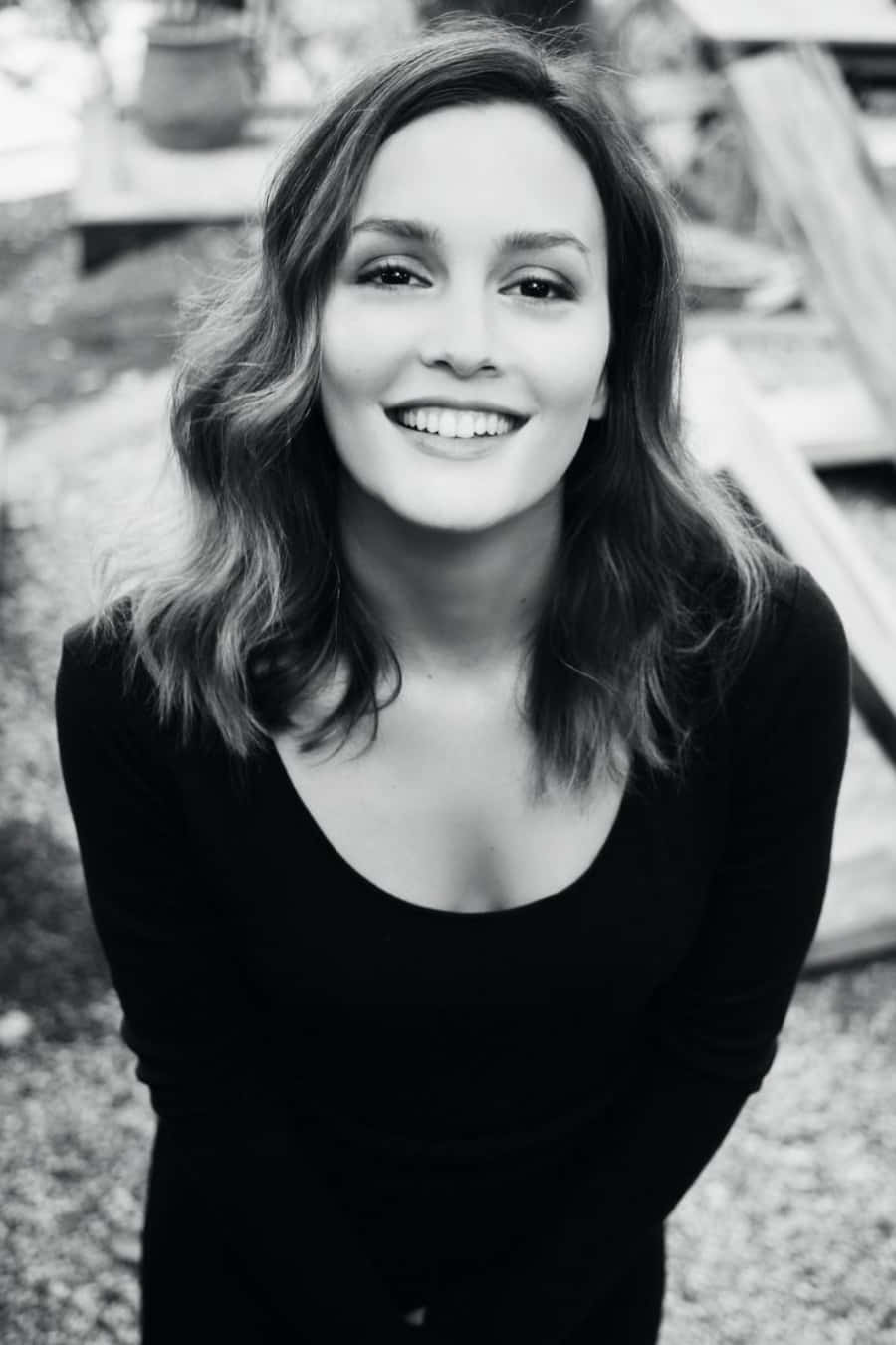 a woman in black and white smiling