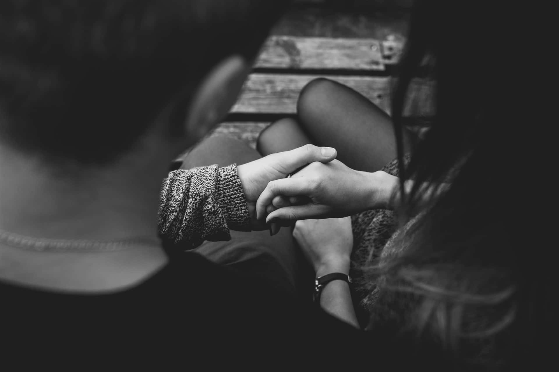 Black And White Shot Of A Couple Holding Each Other's Tangible Hands Wallpaper