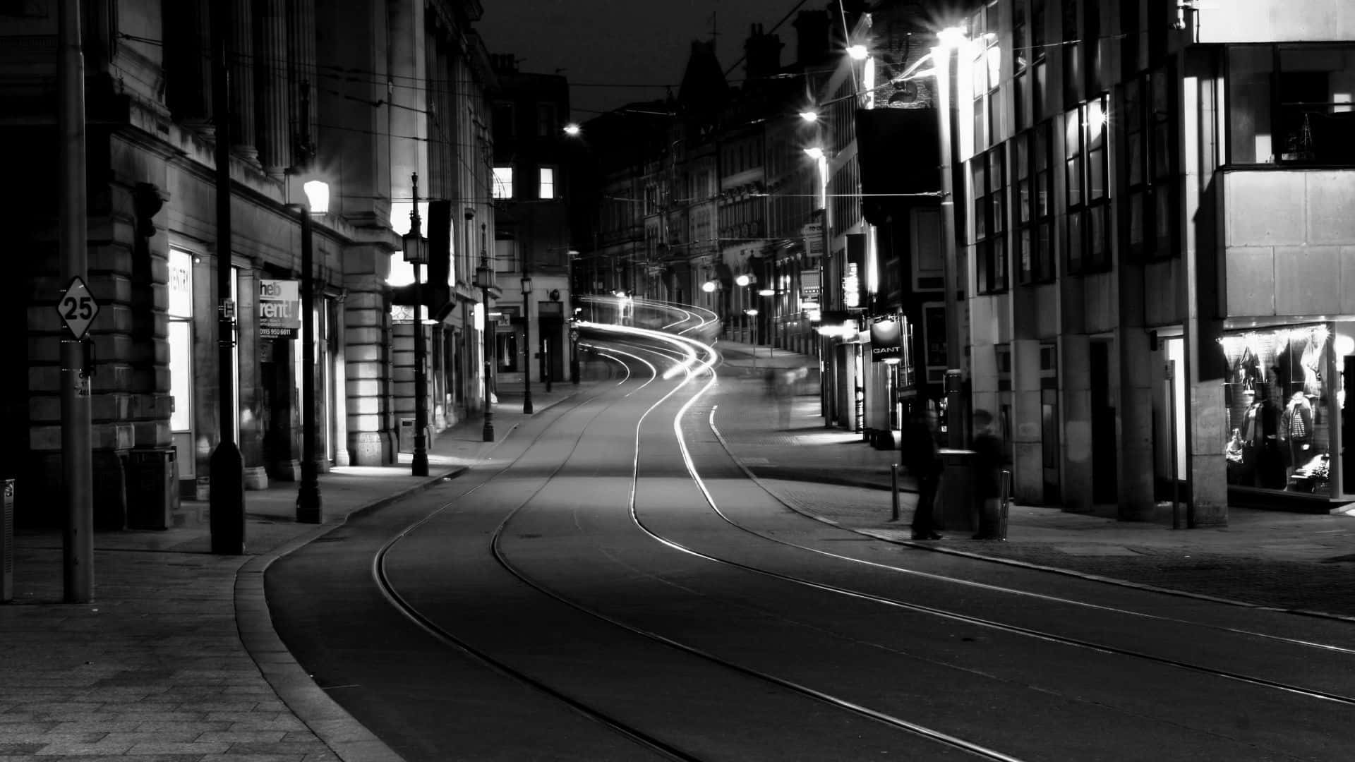 Monochrome urban cityscape with traffic lights and motion-blurred pedestrians Wallpaper
