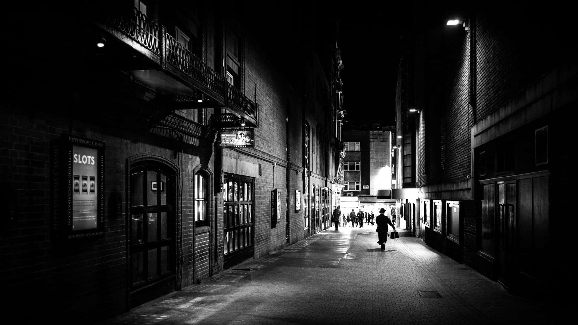A captivating scene of a black and white street in an urban setting Wallpaper