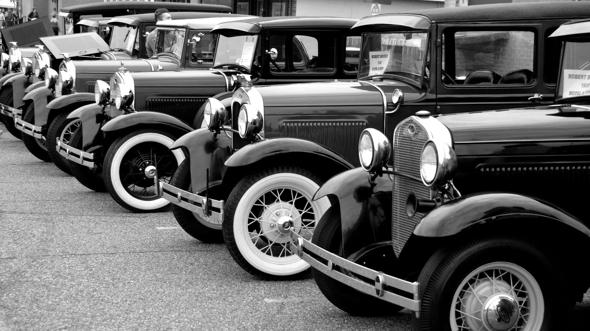 Caption: Timeless Elegance: Black and White Vintage Car Wallpaper