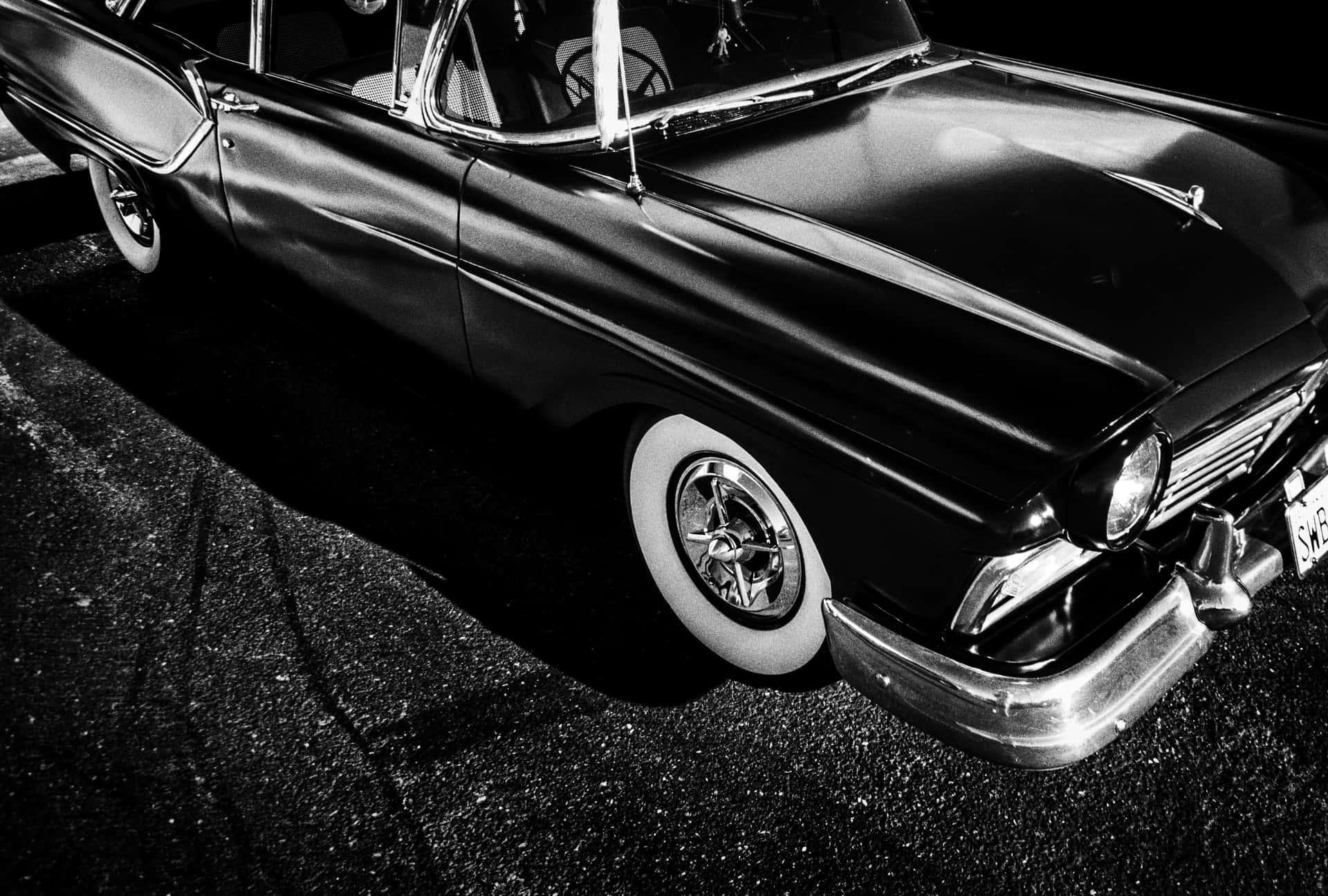 Classic black and white vintage car on a road Wallpaper