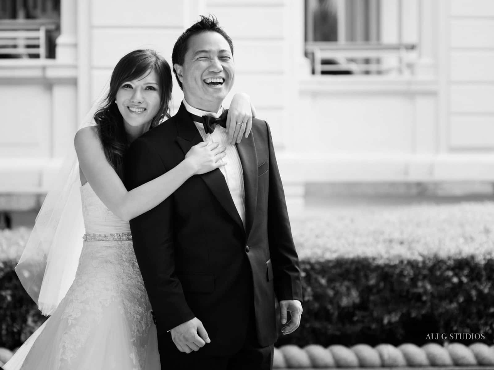 A loving couple sharing a romantic moment at their black and white themed wedding Wallpaper