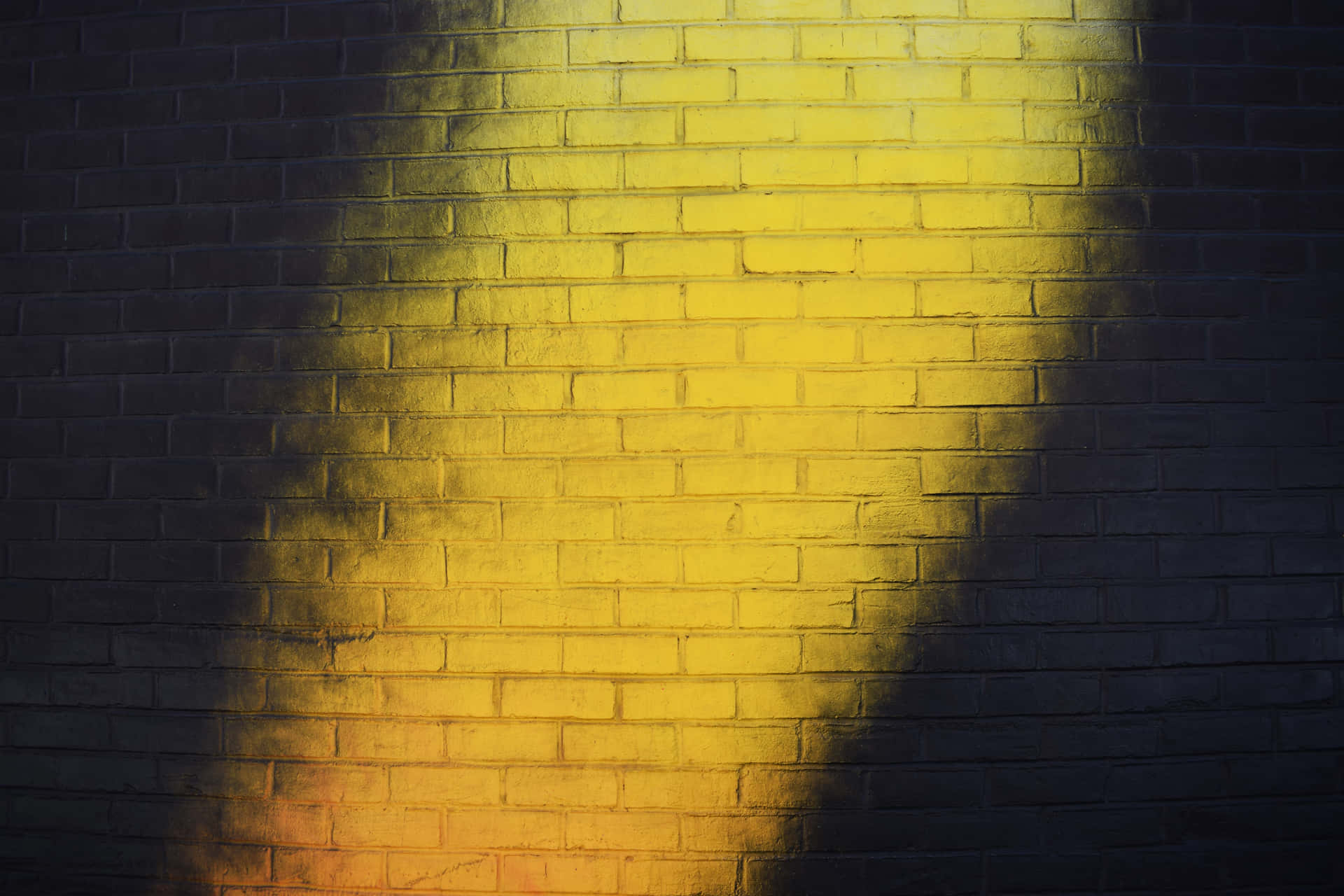 A Yellow Light Is Shining On A Brick Wall