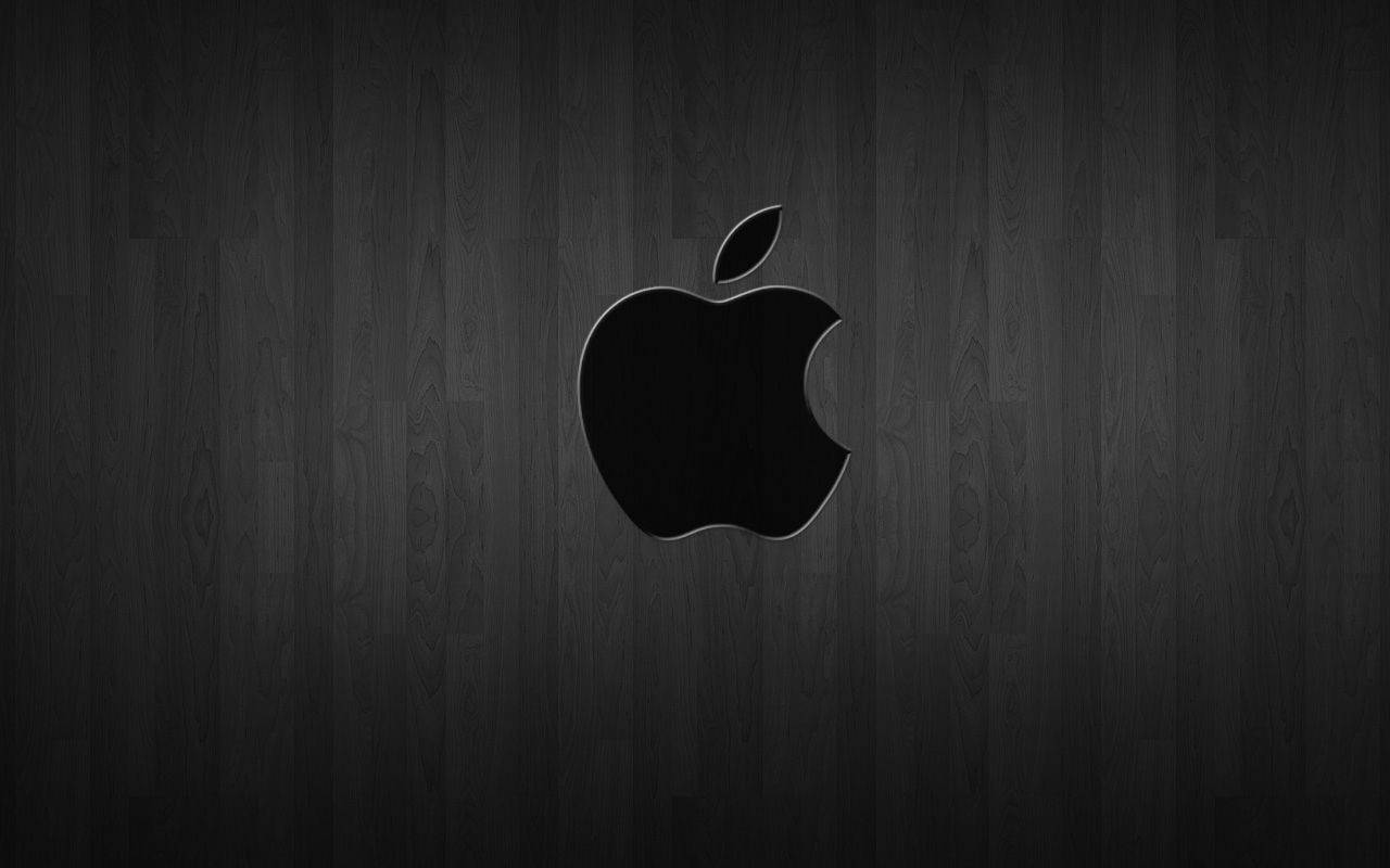 Black Apple Logo On Dark Wood