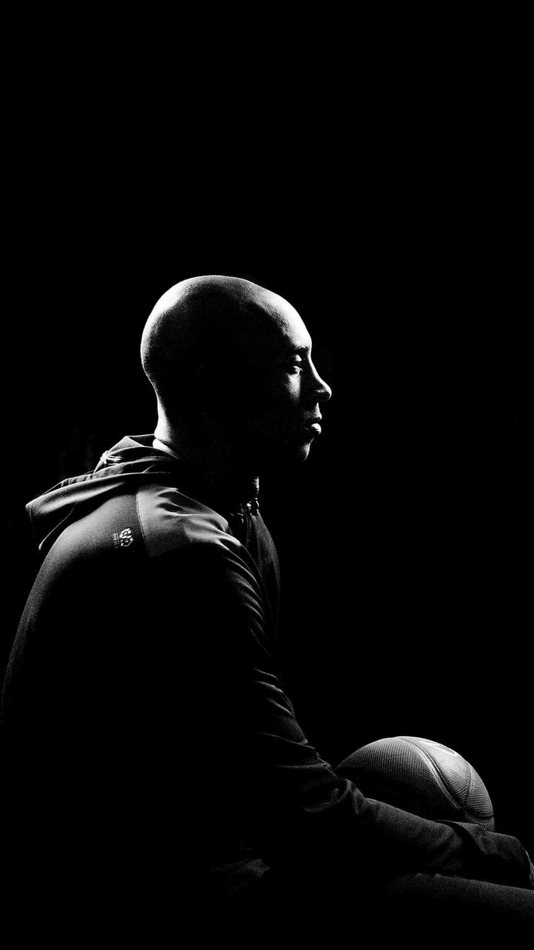 black and white photo of kobe sitting holding a basketball photographed  from the side kobe wallpaper