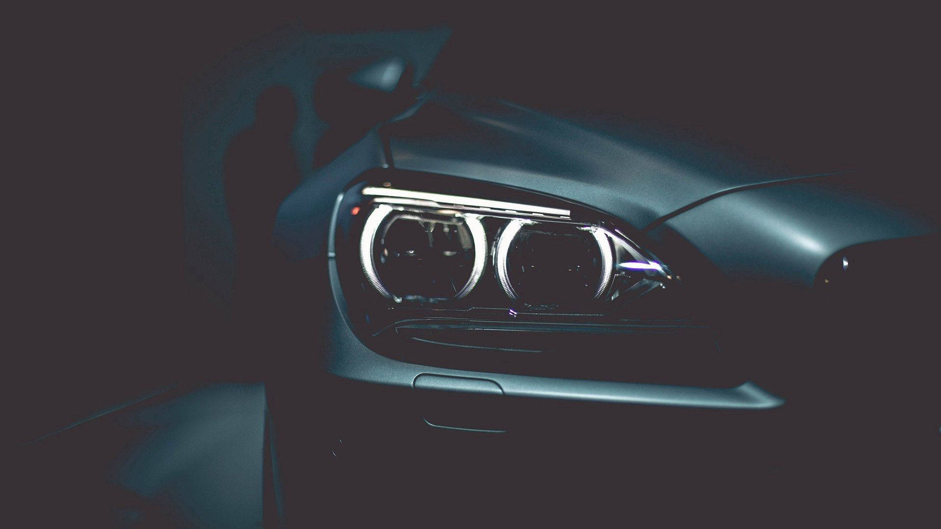 Close-up wallpaper of black BMW car's headlights
