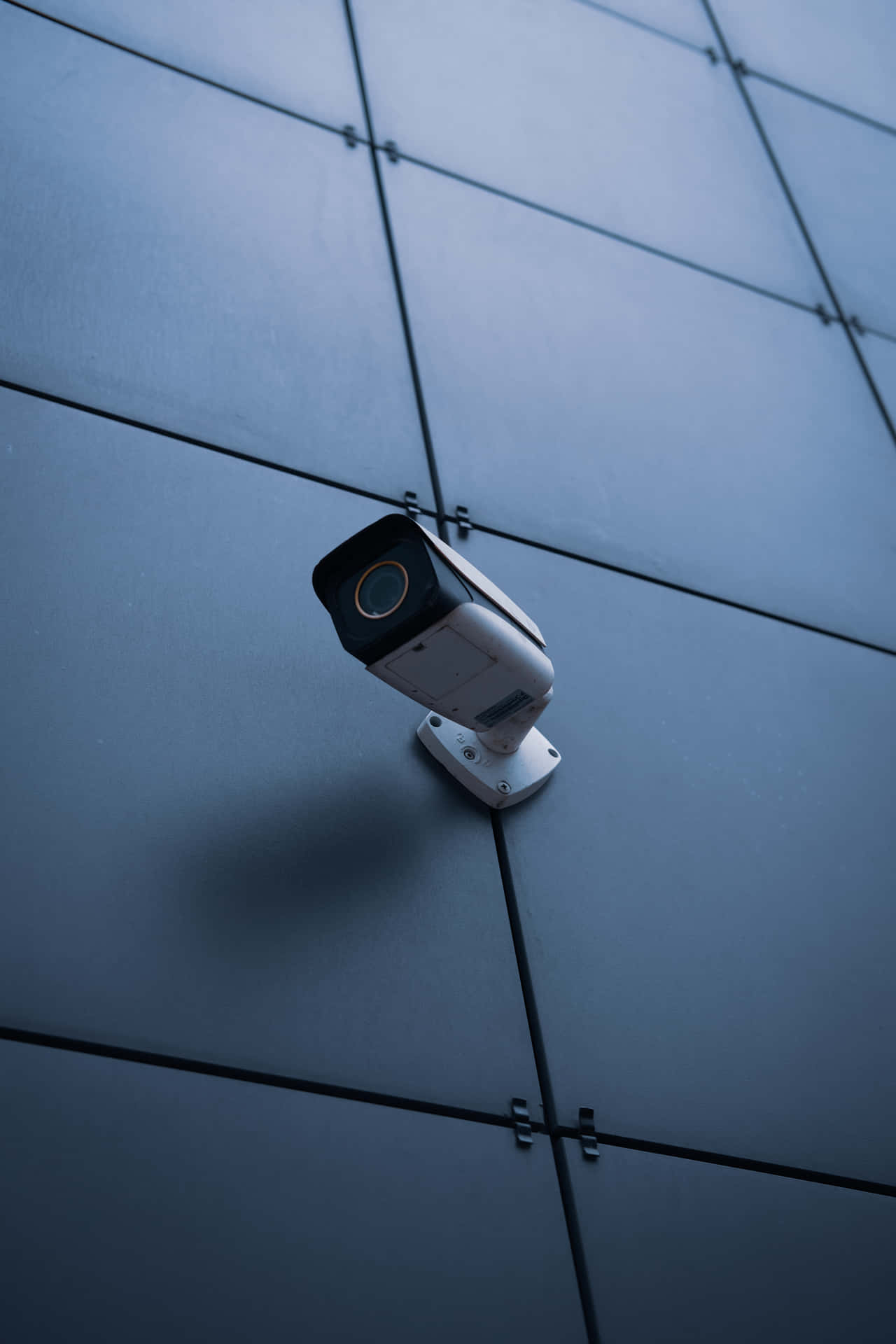 Black Bullet Security Camera Mounted On Wall Wallpaper