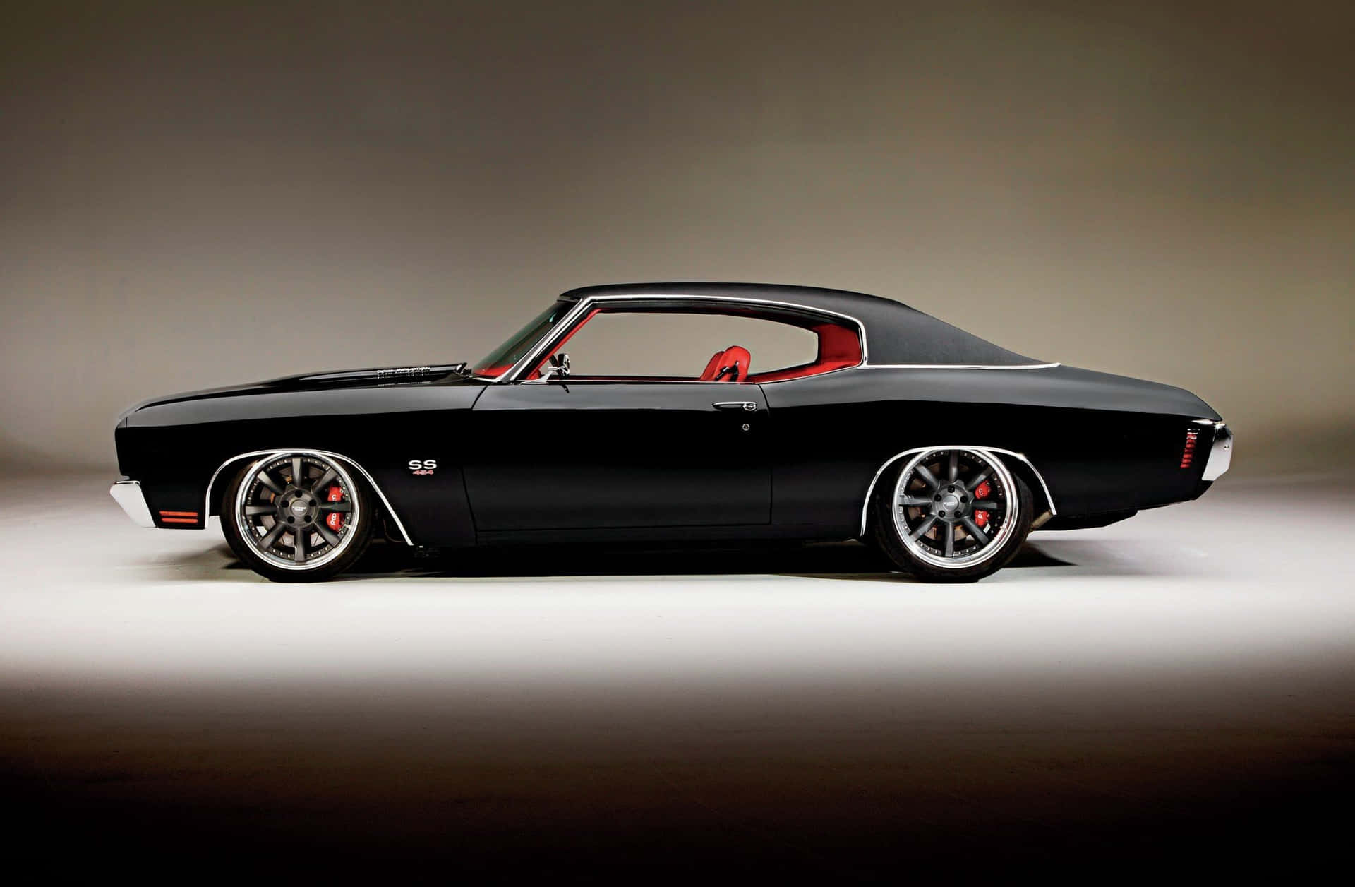 A Black Muscle Car Is Parked In A Studio