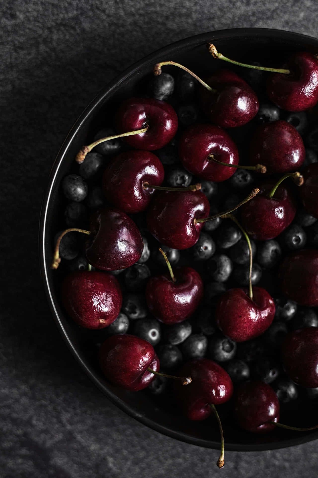 A beautiful and fragrant black cherry on a sunny day Wallpaper