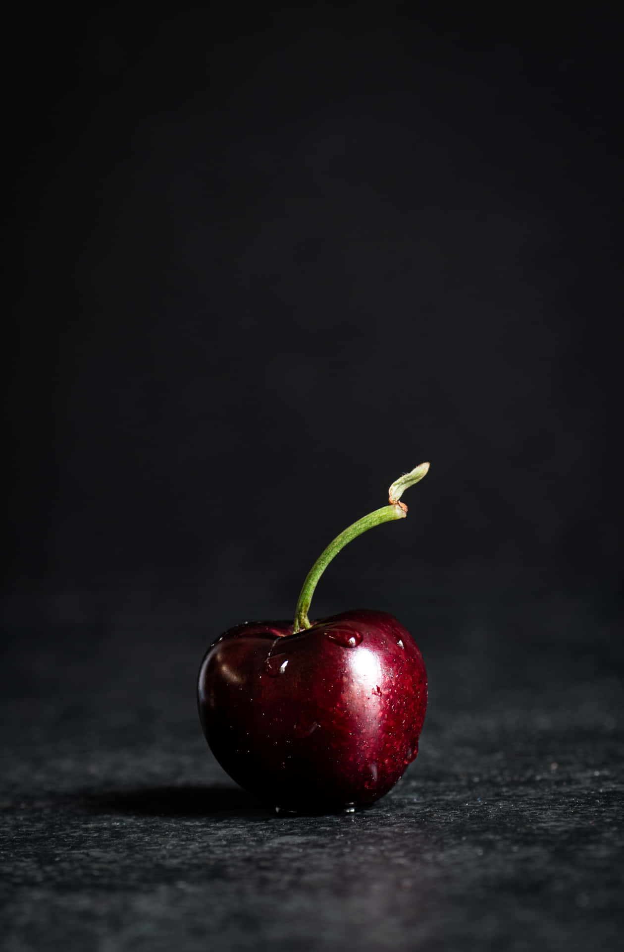 A close-up of a fresh black cherry. Wallpaper