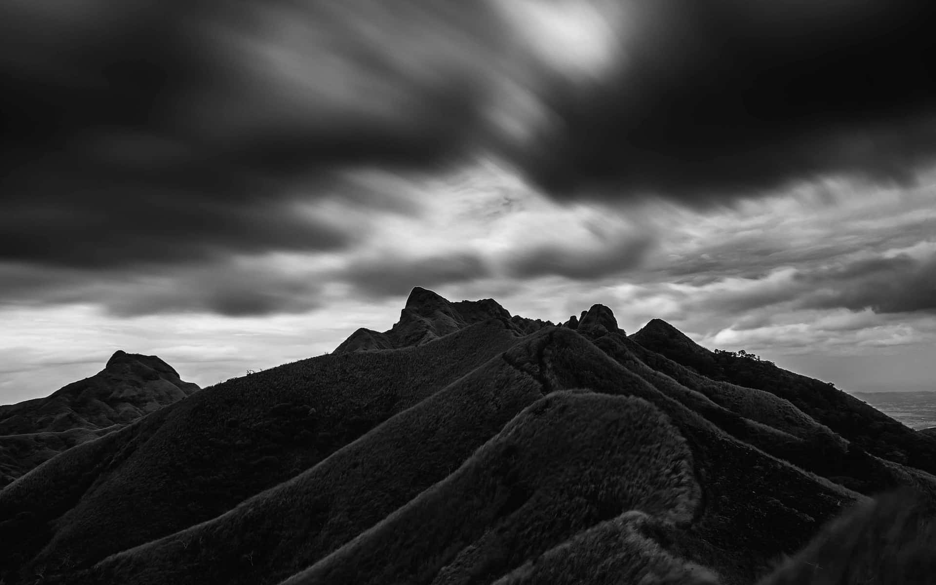 Black Clouds Above Fold Mountains Wallpaper