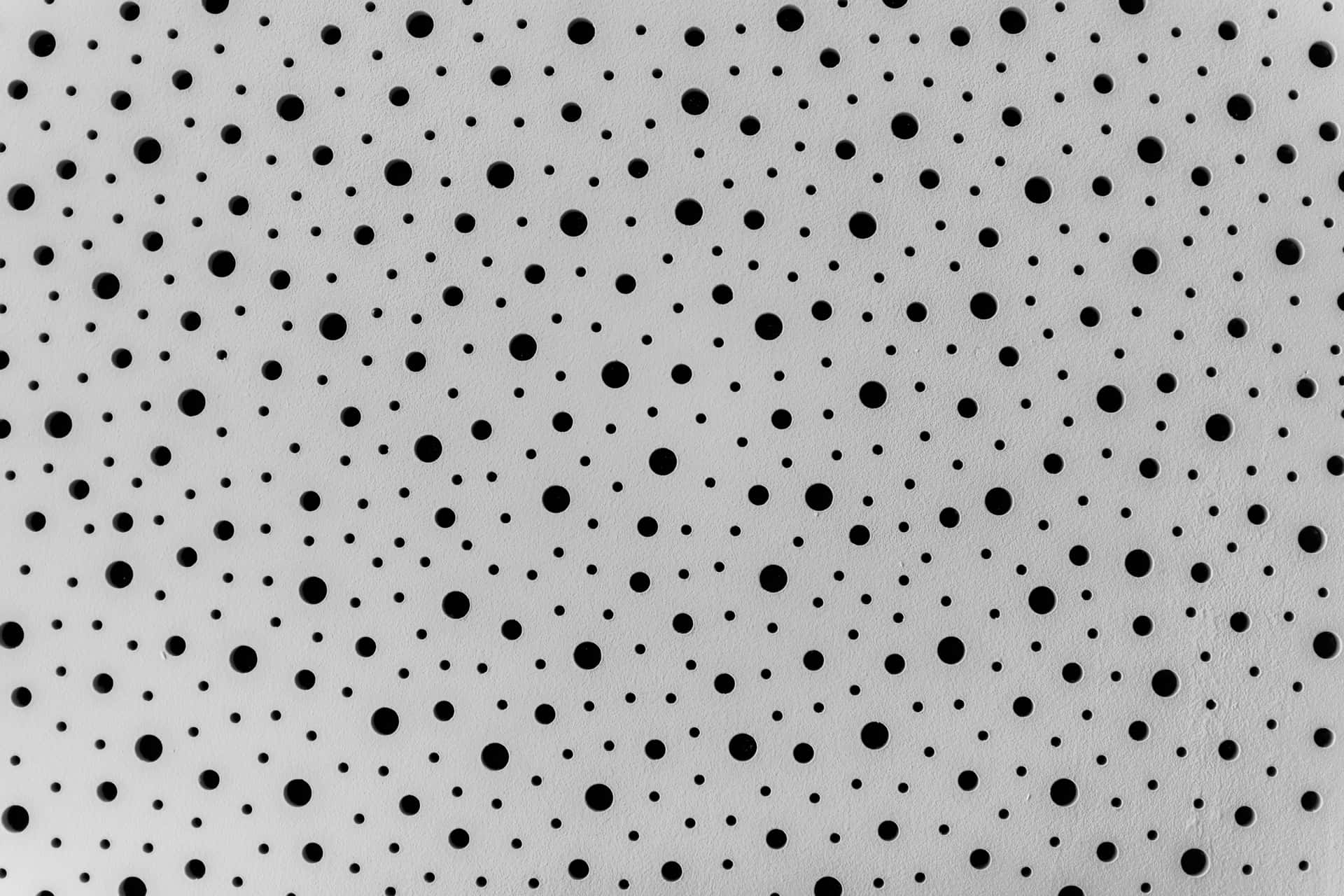 Abstract artwork of black dots on a white canvas Wallpaper