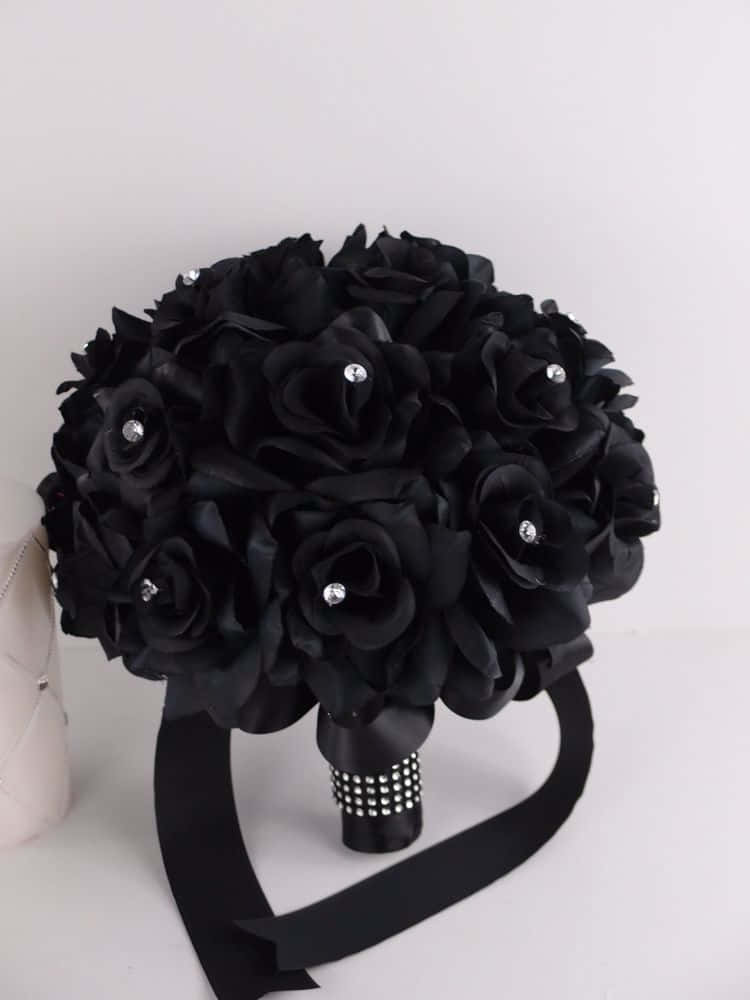 A delicate black flower on a blurred background