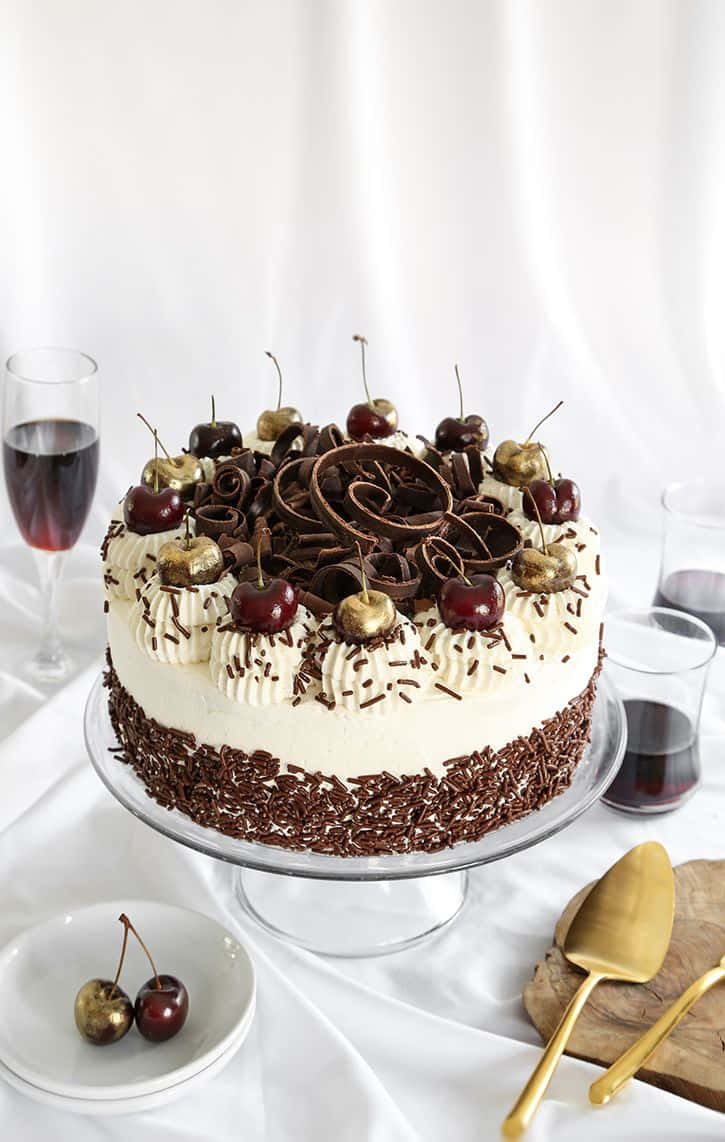 Delicious Black Forest cake covered in chocolate shavings and cherries Wallpaper