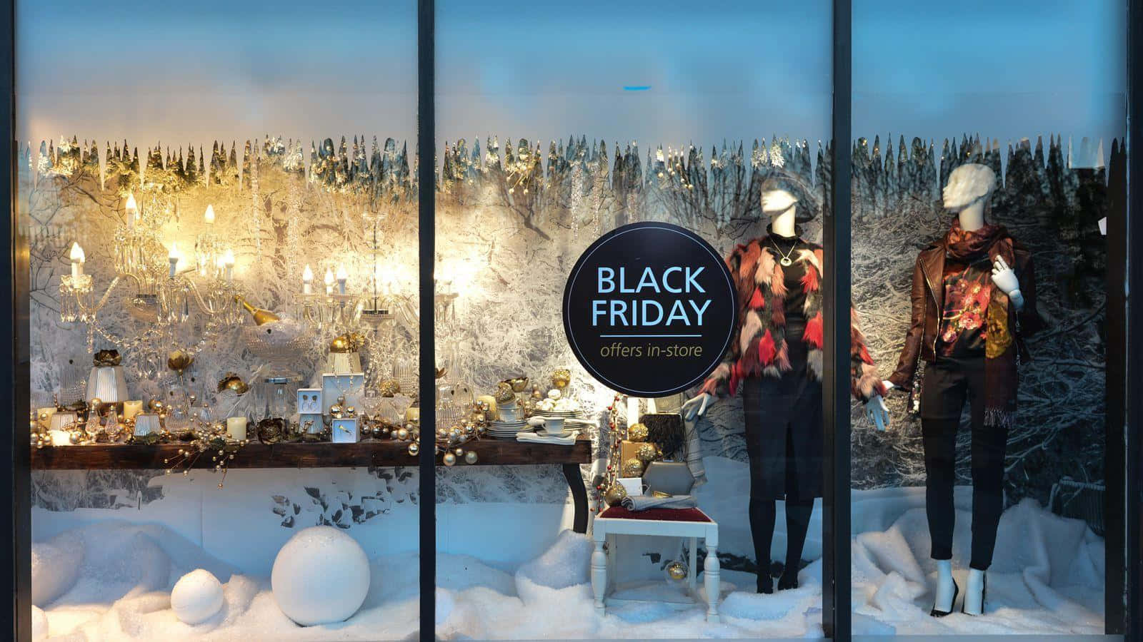 A Black Friday Window Display With Mannequins And Snow
