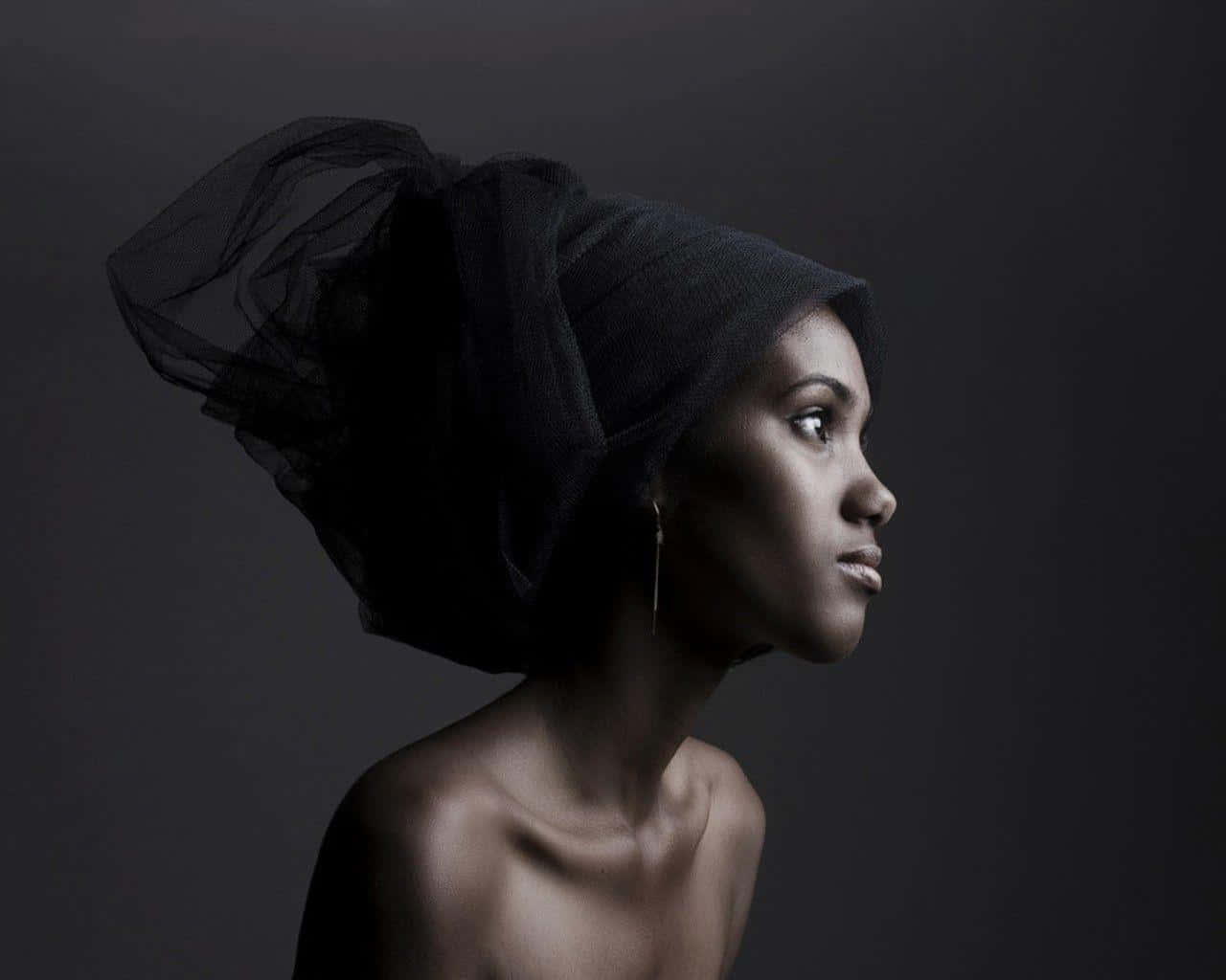 A Black Woman Wearing A Turban Wallpaper