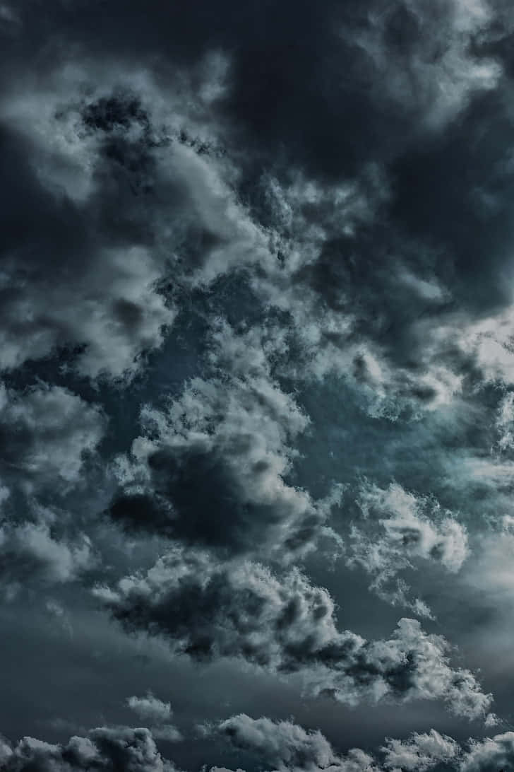 A Dark Sky With Clouds And A Moon Wallpaper