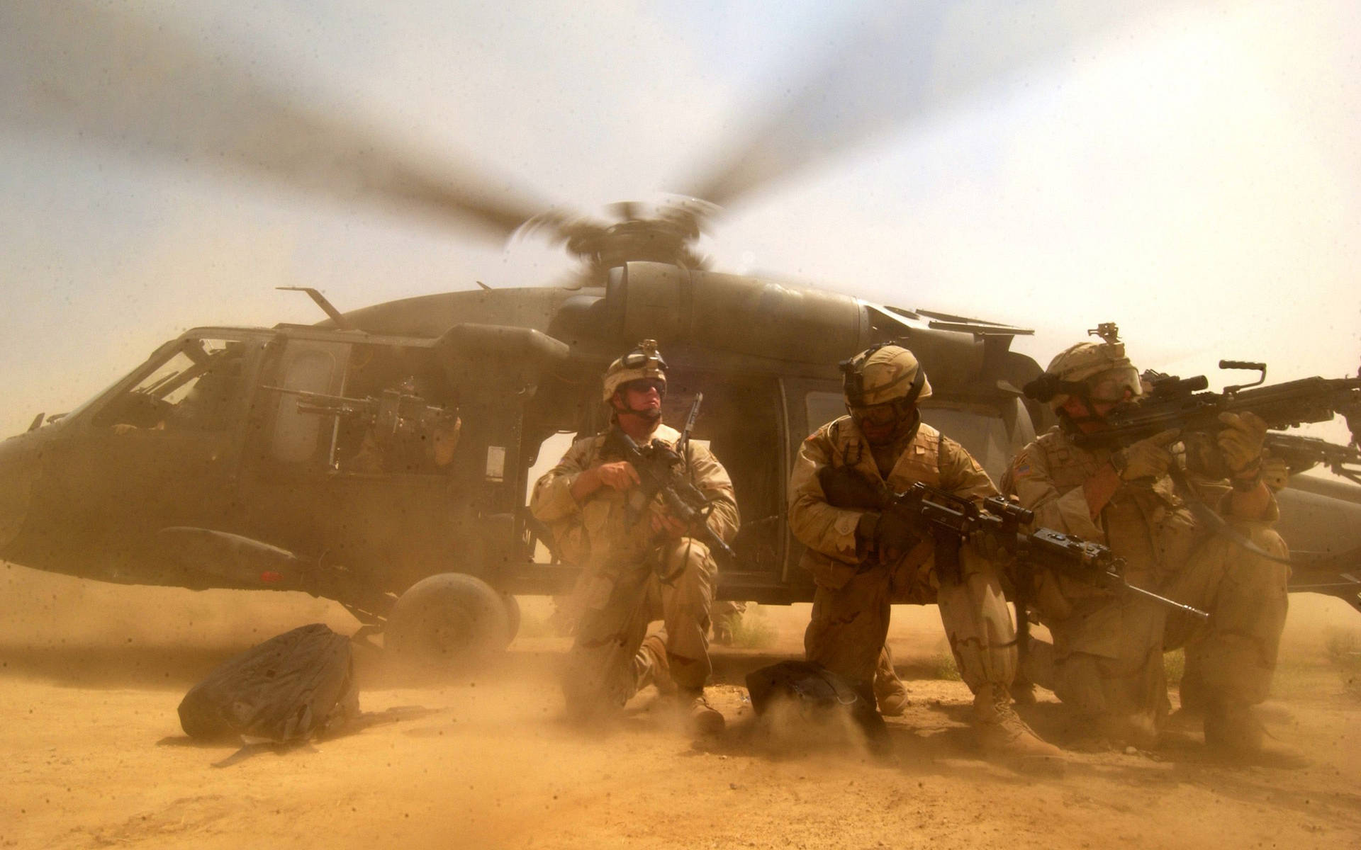 Soldiers On Ground With Black Hawk Helicopter Wallpaper