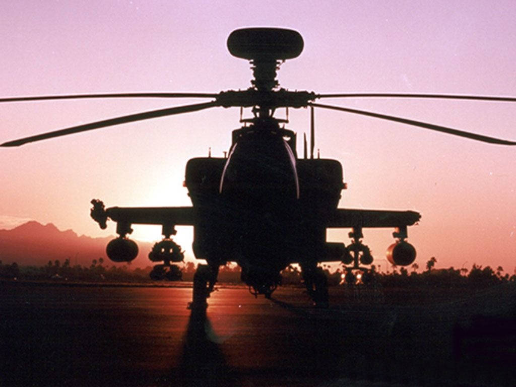 A Military Black Hawk Helicopter Cutting Through the Air Wallpaper