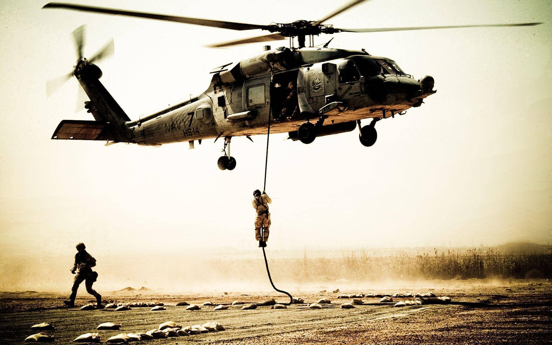 A Black Hawk helicopter soars through the sky Wallpaper