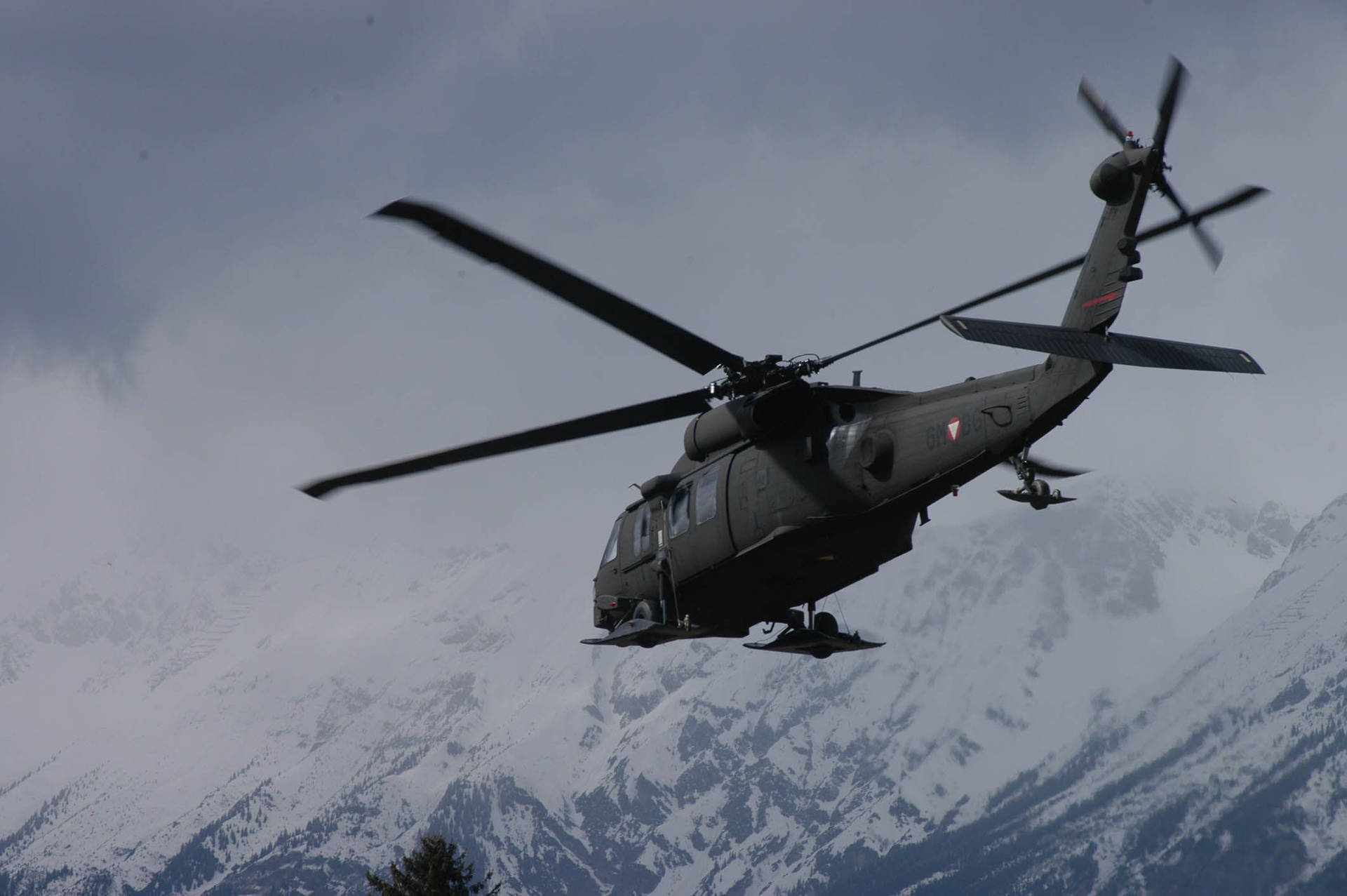 Uh 60 Black Hawk Helicopter Against Icy Mountain Wallpaper