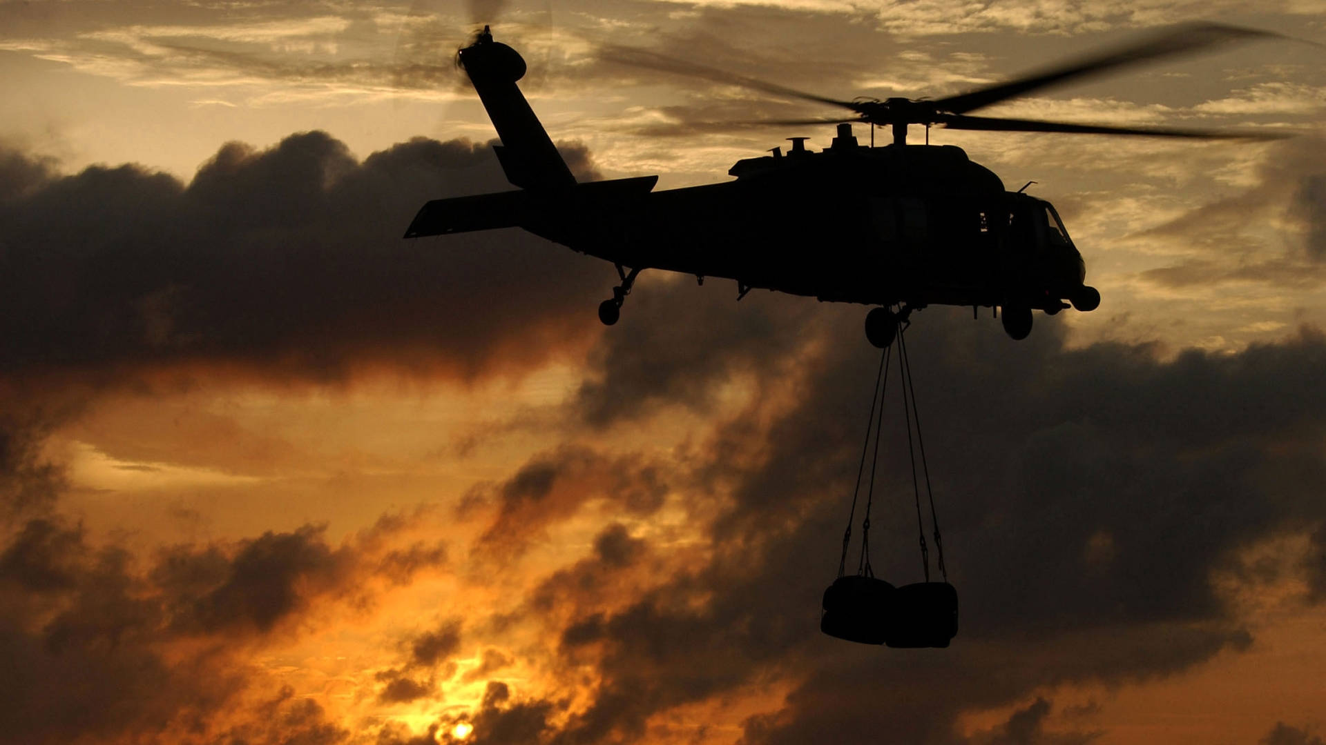 Black Hawk Helicopter Carrying Supplies Wallpaper