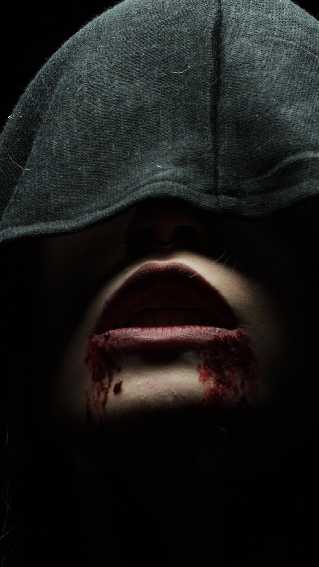 A mysterious vampire covered in a dark hood and drenched with blood Wallpaper