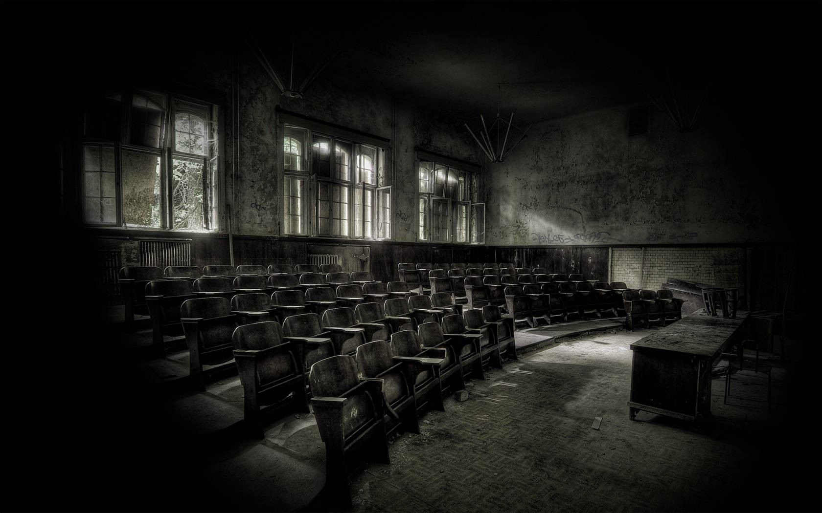 The eerie silence of a dimly lit, deserted classroom. Wallpaper
