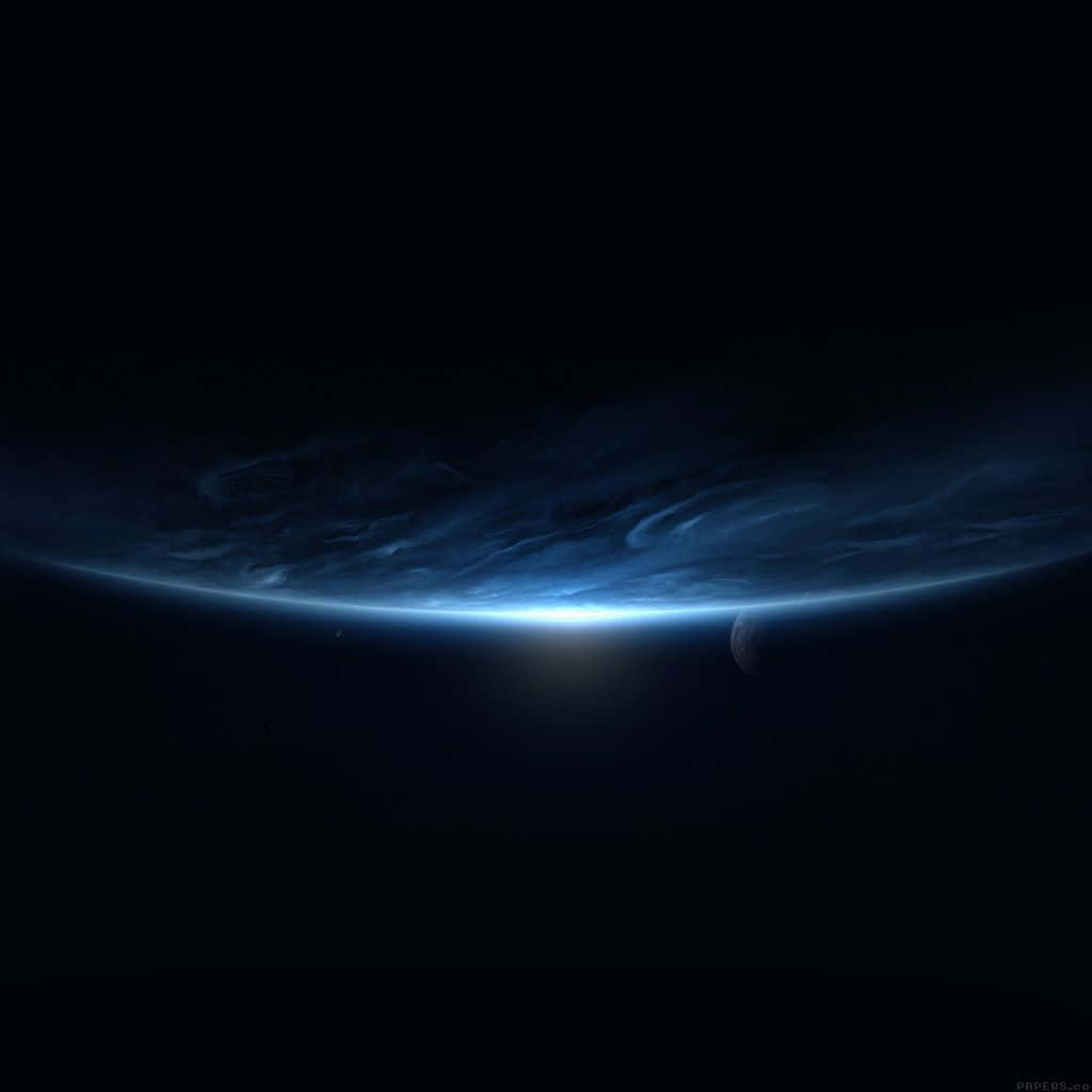 Black Ipad With Blue Planet In Outer Space Wallpaper