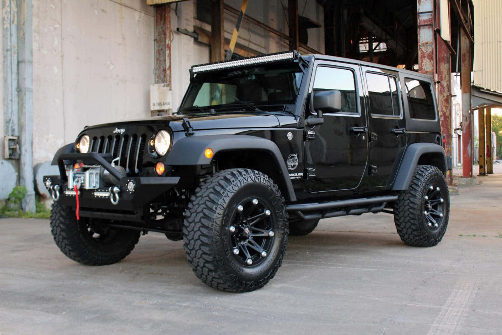 A Black Jeep Parked In Front Of A Building