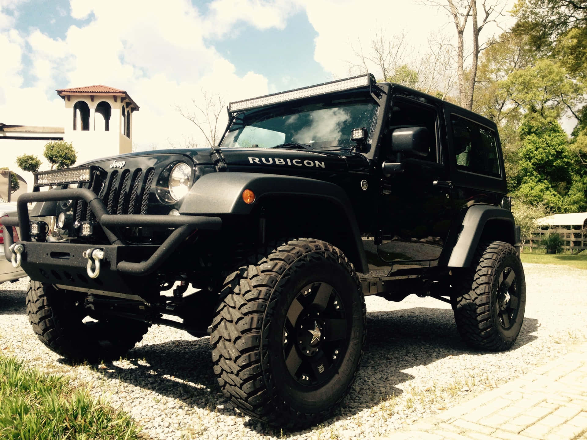 A Black Jeep Parked In A Driveway