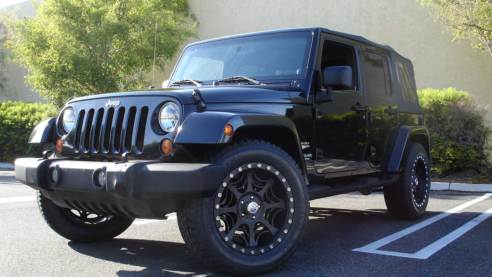 A Black Jeep Parked In A Parking Lot