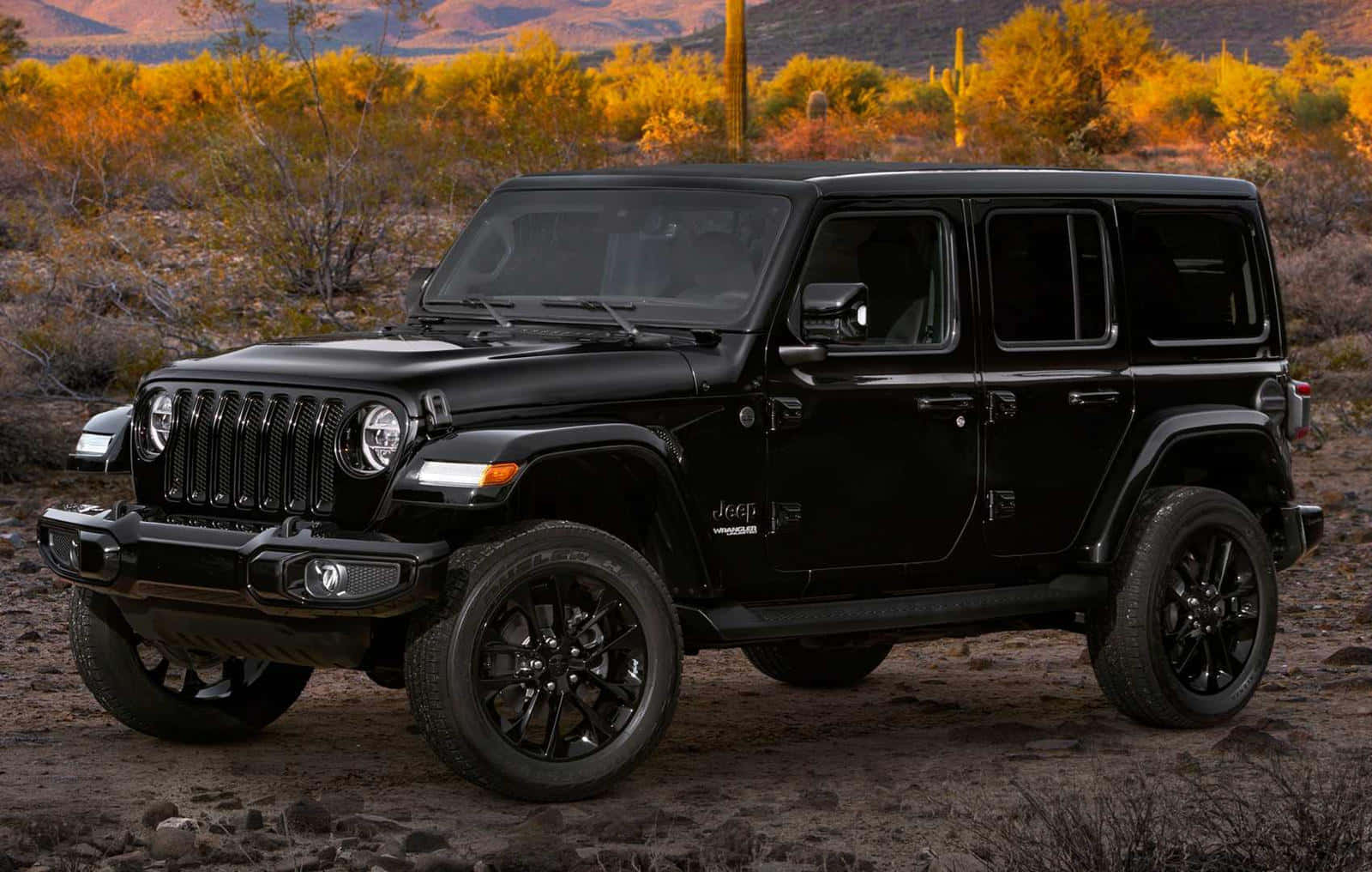 A Black Jeep Parked In The Desert