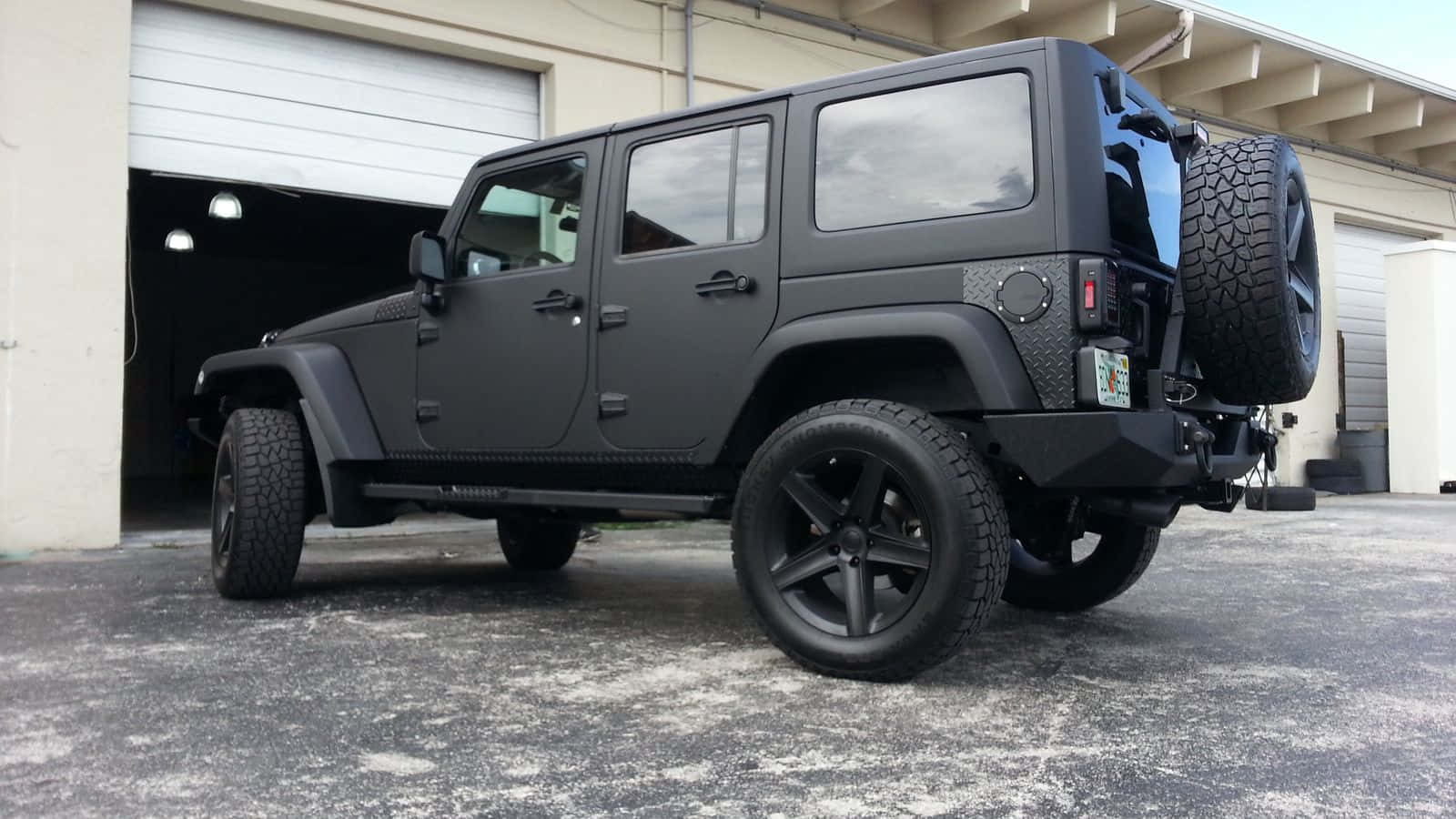 A sleek black Jeep looks ready for a mountain adventure.