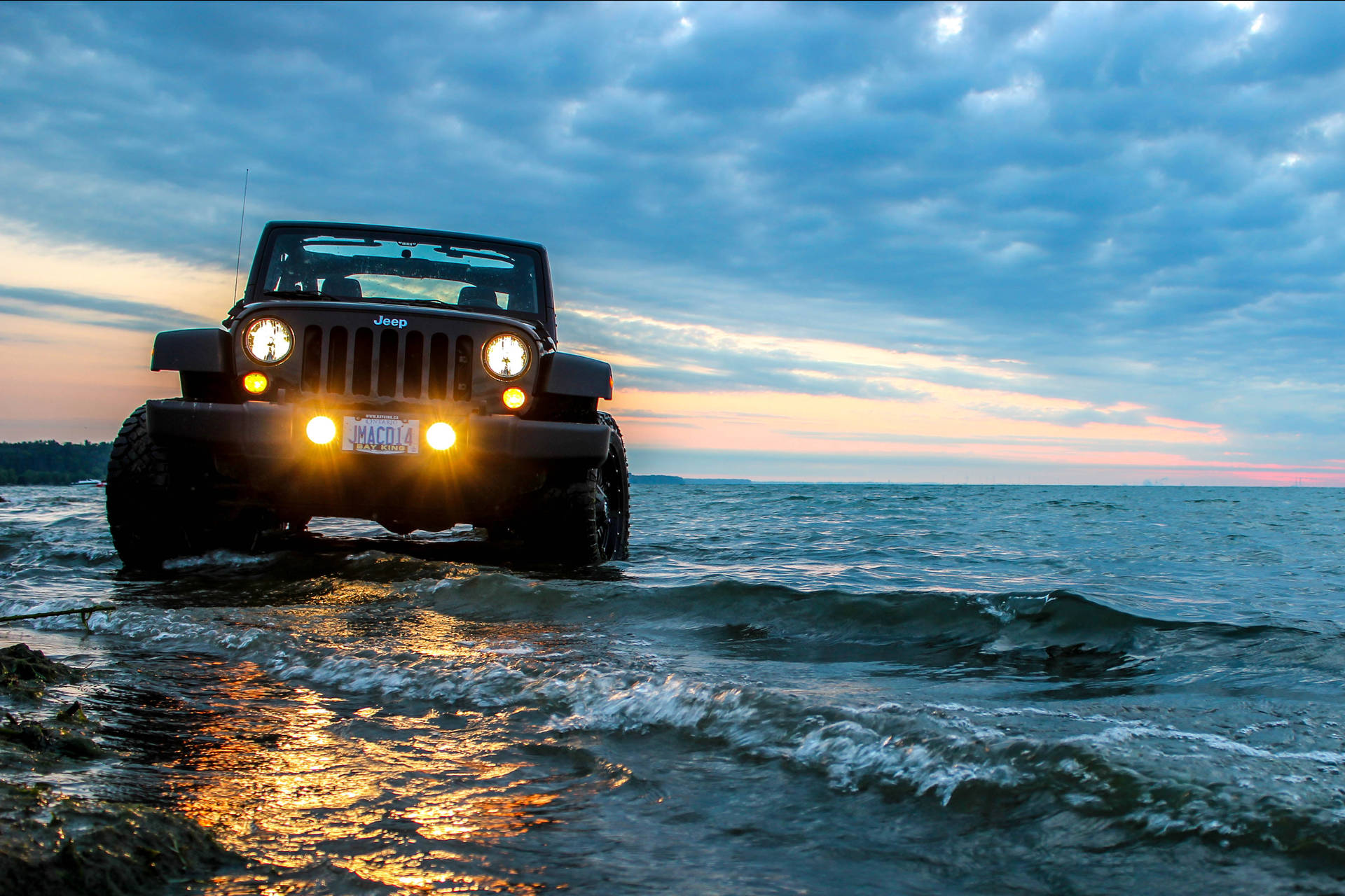 Black Jeep Wrangler On Ocean Background