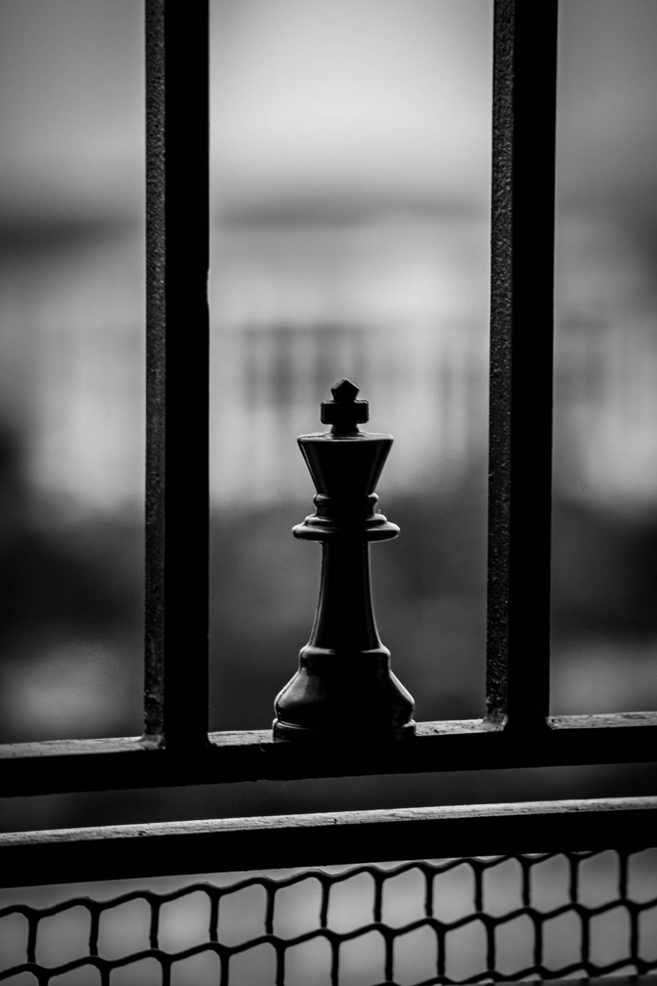 Black King Chess Piece On A Railing Wallpaper
