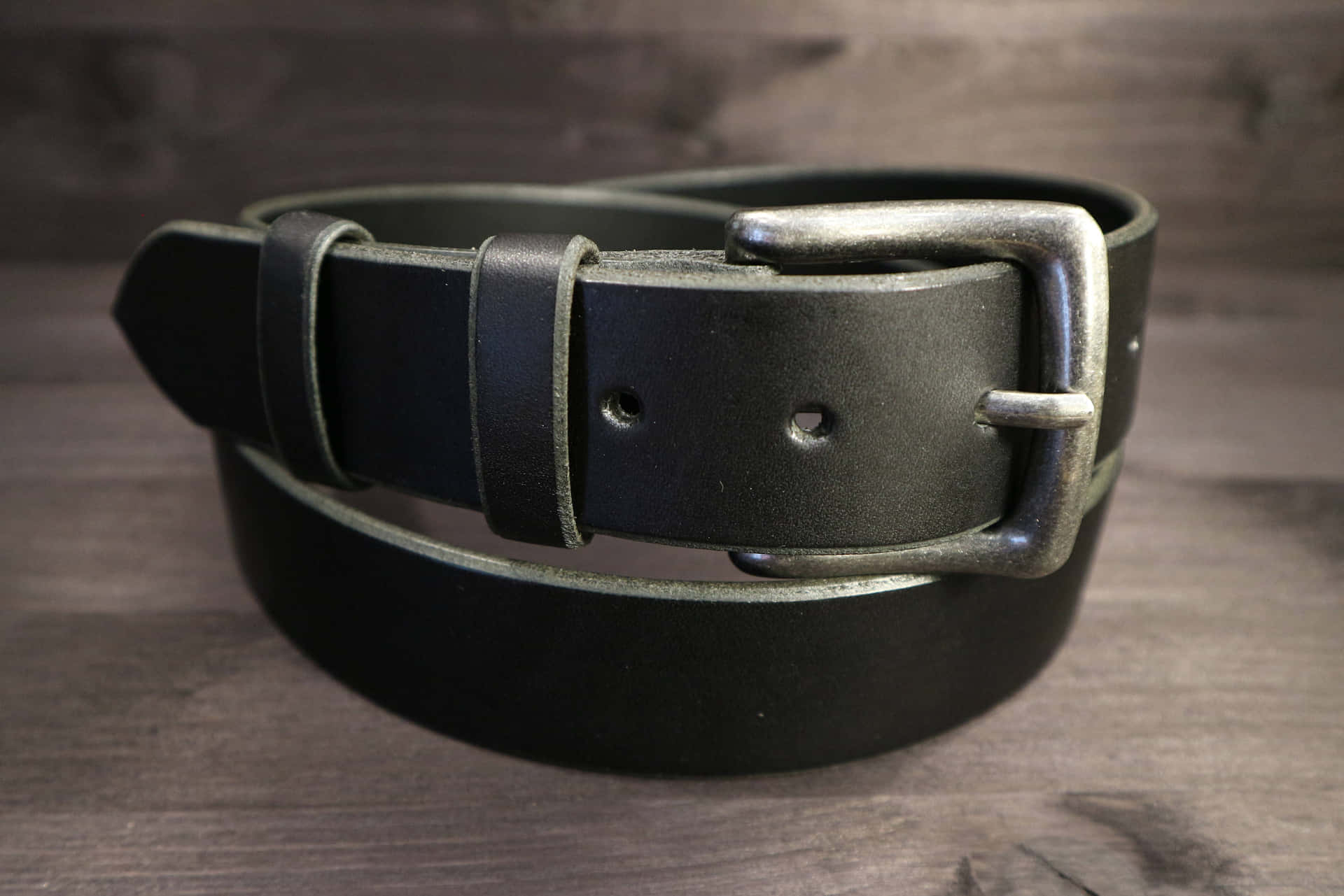 Download A Black Leather Belt With A Silver Buckle | Wallpapers.com