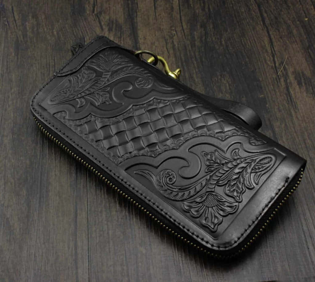A Black Leather Wallet With A Paisley Pattern