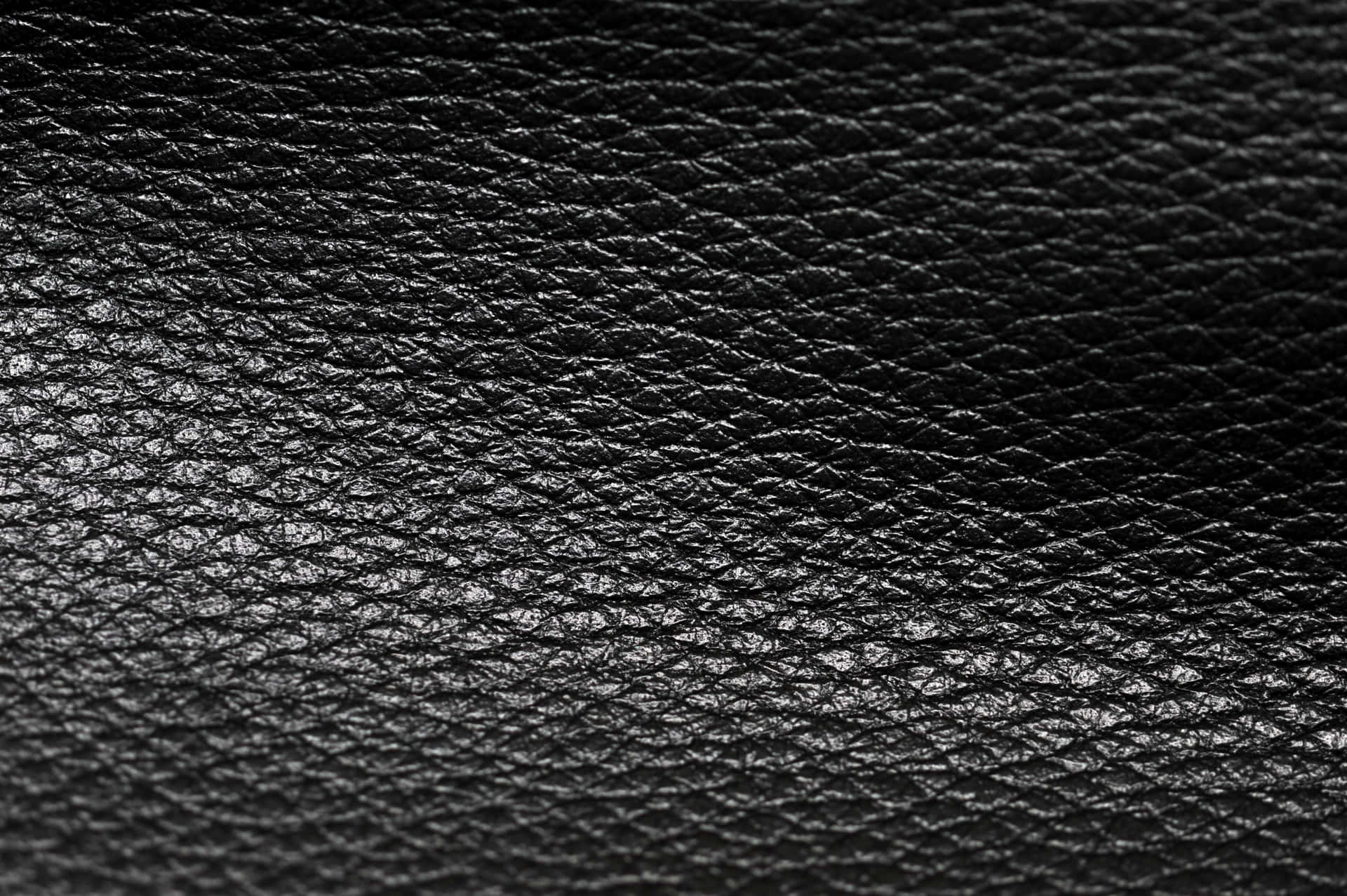 Download A Close Up Of A Black Leather Texture | Wallpapers.com