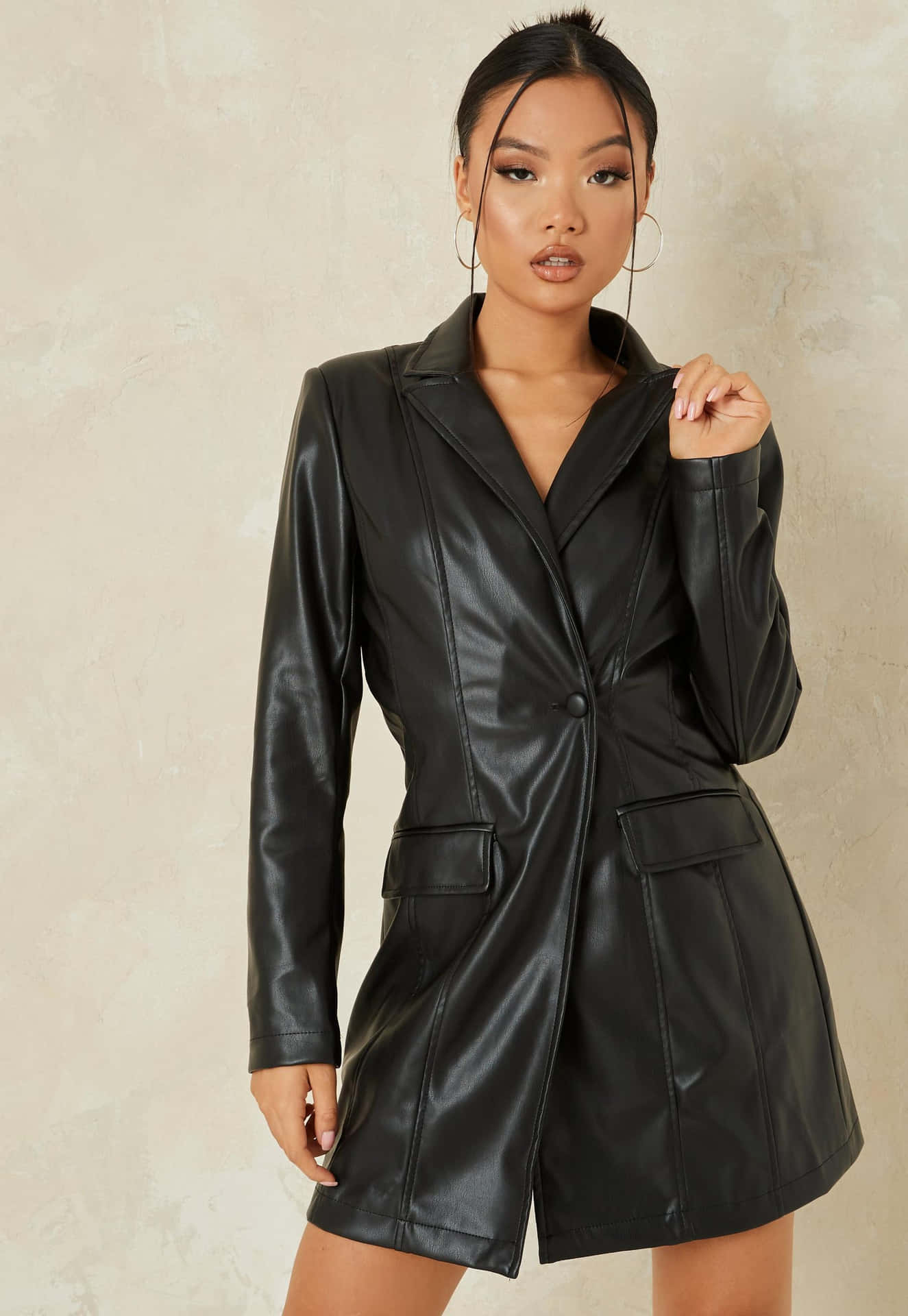 A Woman In A Black Leather Blazer Dress
