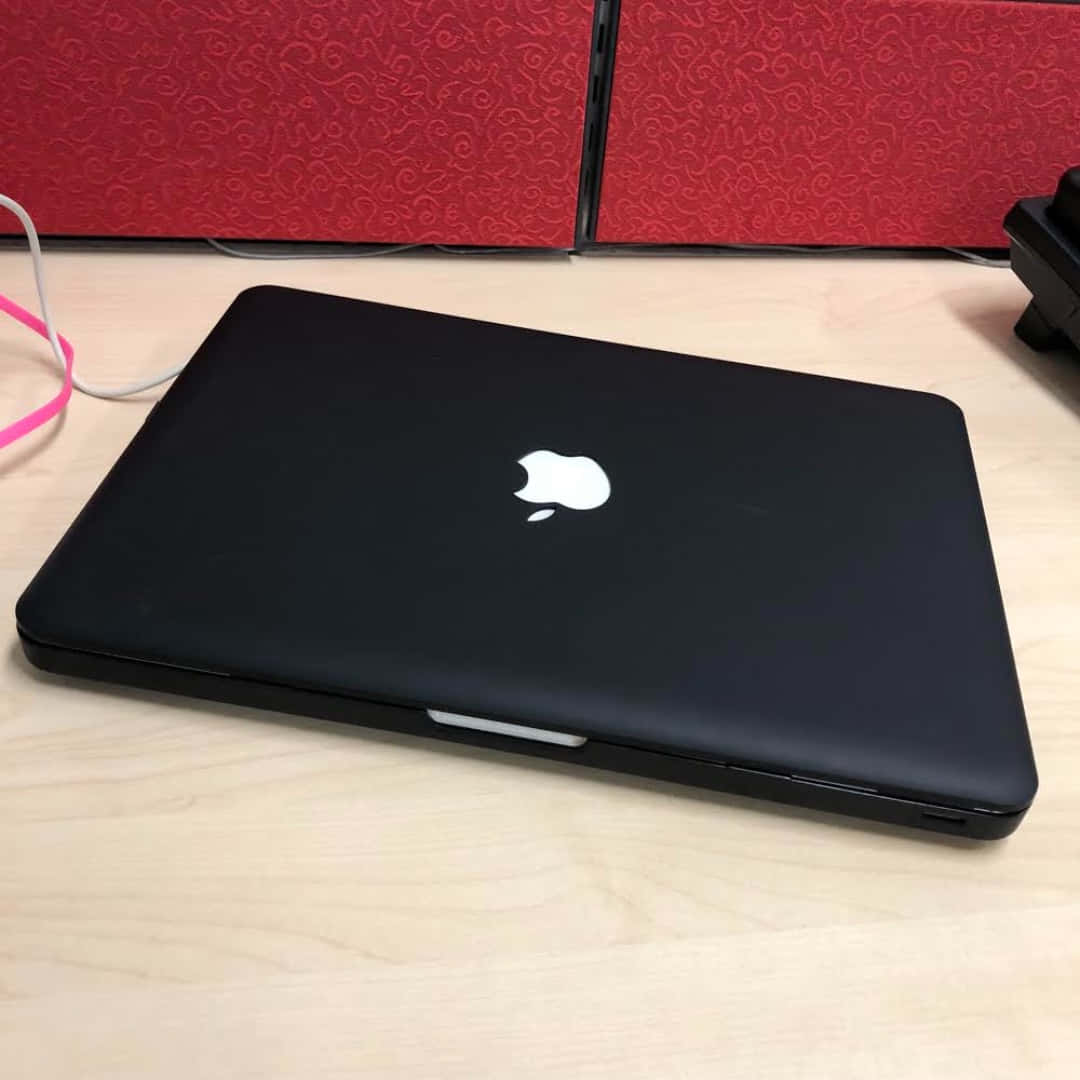 A sleek and stylish black Macbook laptop Wallpaper