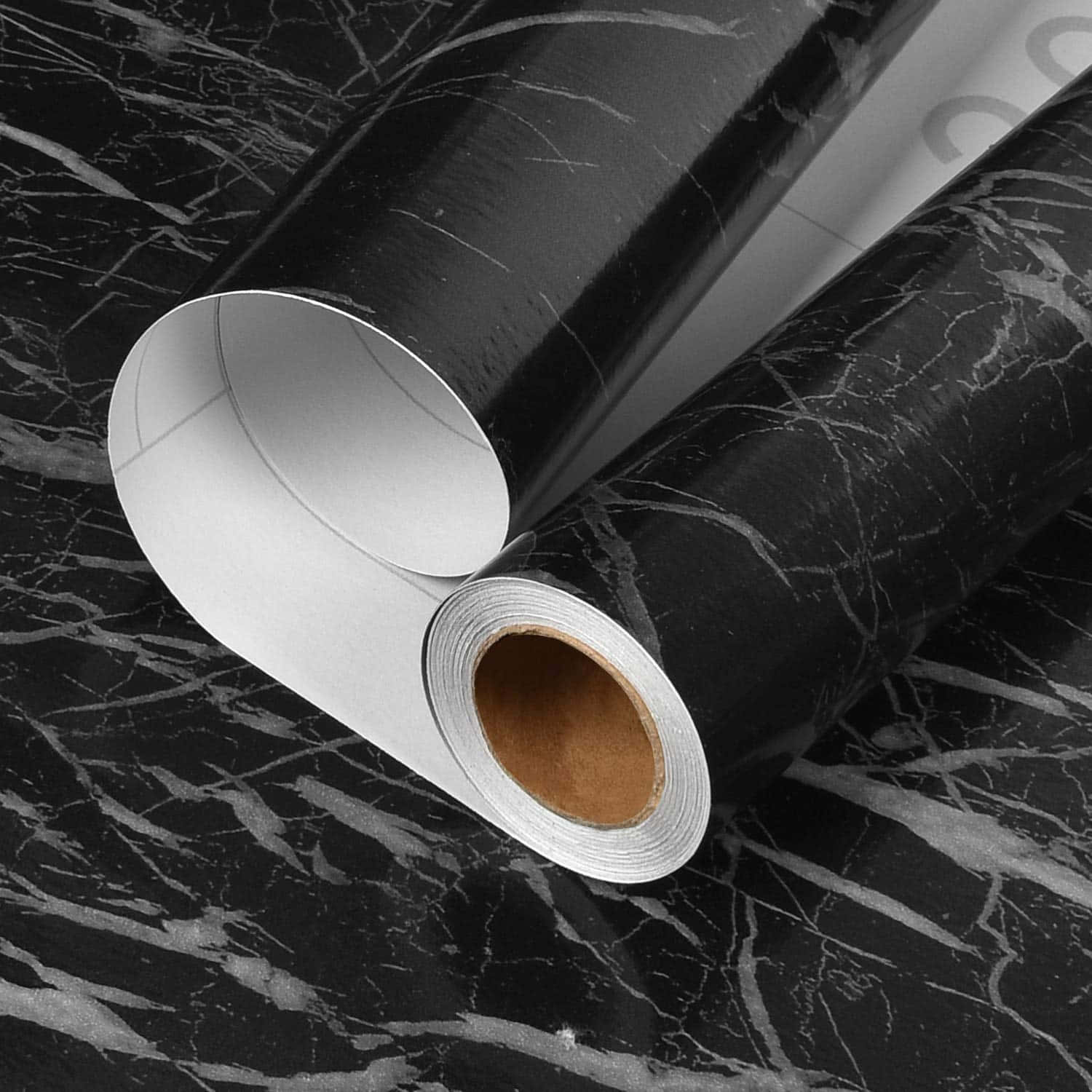 A Roll Of Black Marble Paper On A Table