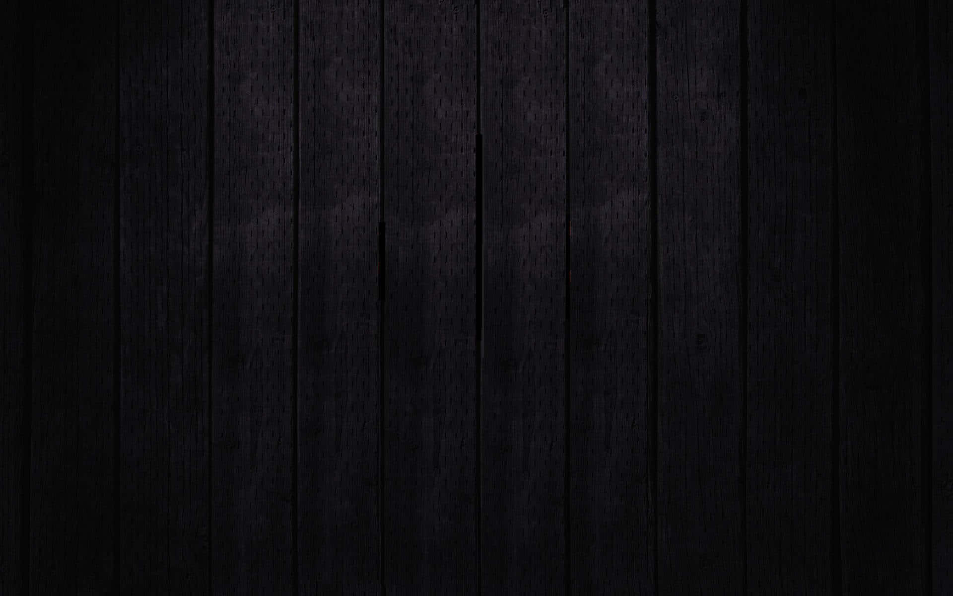 Einschwarzer Holzhintergrund Mit Einem Dunklen Hintergrund. Wallpaper
