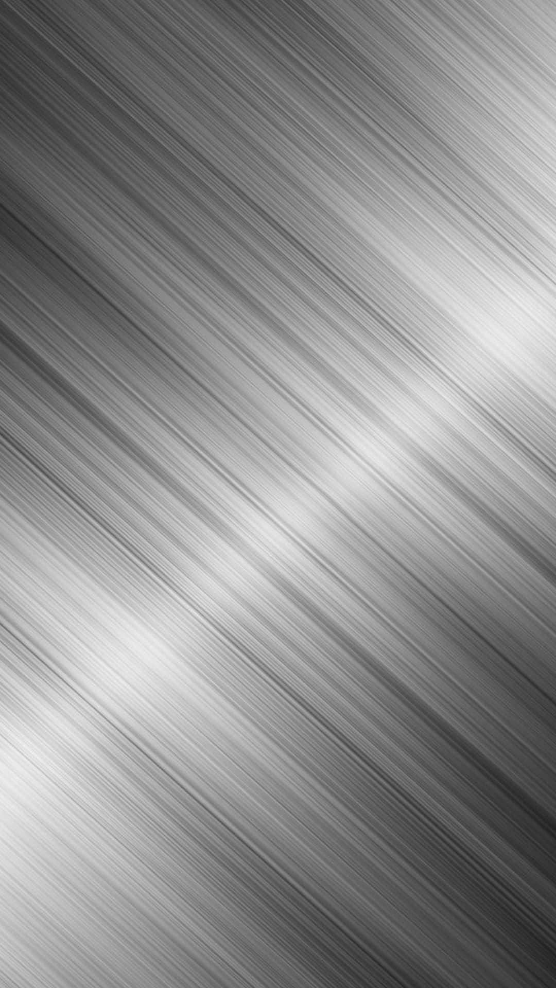 En glansfuld sort metallic overflade reflekterer i et lyst oplyst rum Wallpaper