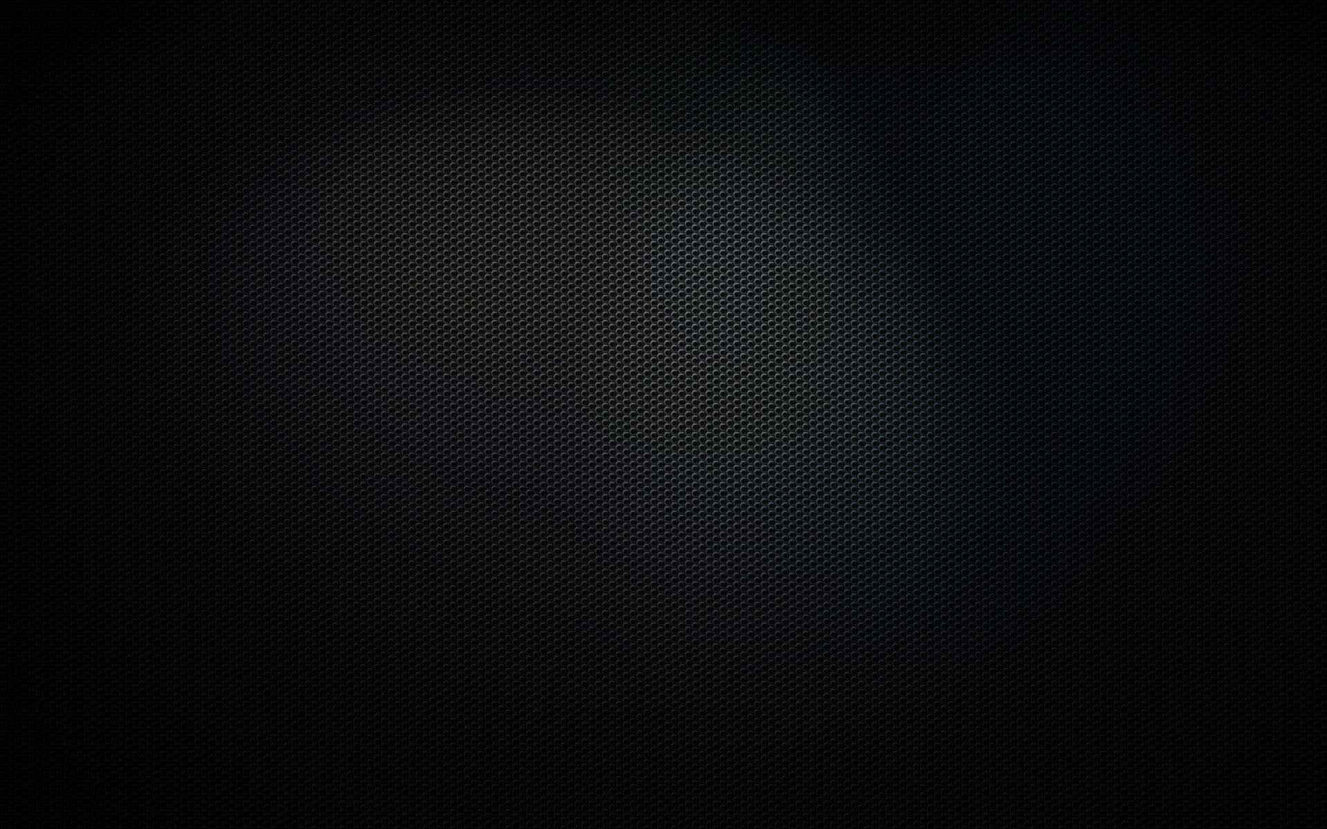 Unasuperficie Elegante De Metal Negro Brilla Bajo La Luz. Fondo de pantalla