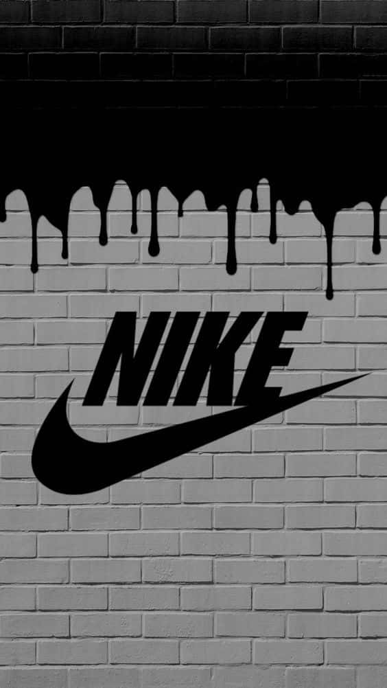 Et Nike logo på en mur af mursten Wallpaper