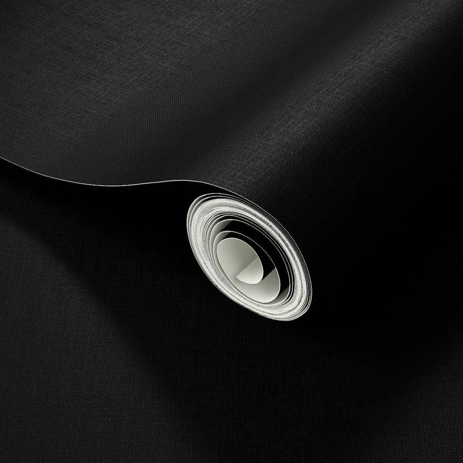 En sort rulle papir på en overflade Wallpaper