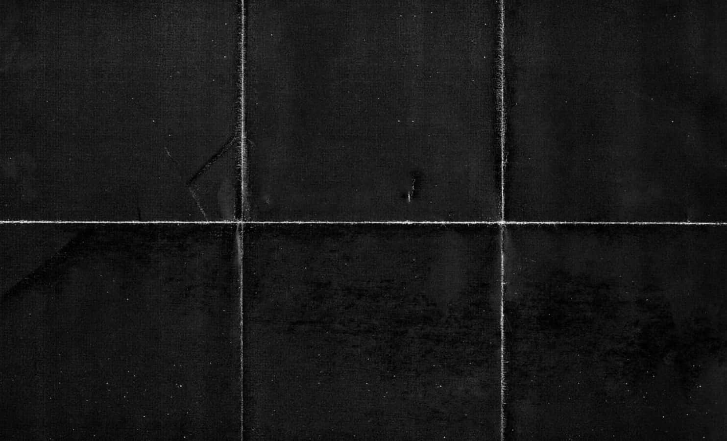 Black Tiled Wall With A Black Background
